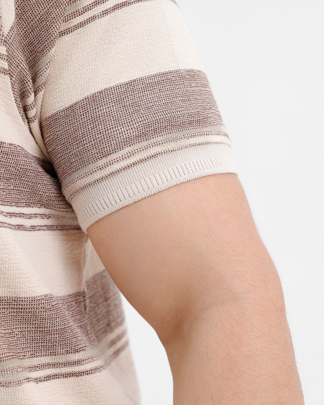 Man wearing a retro classic checked all over printed polo t shirt with casual styling on a gray background