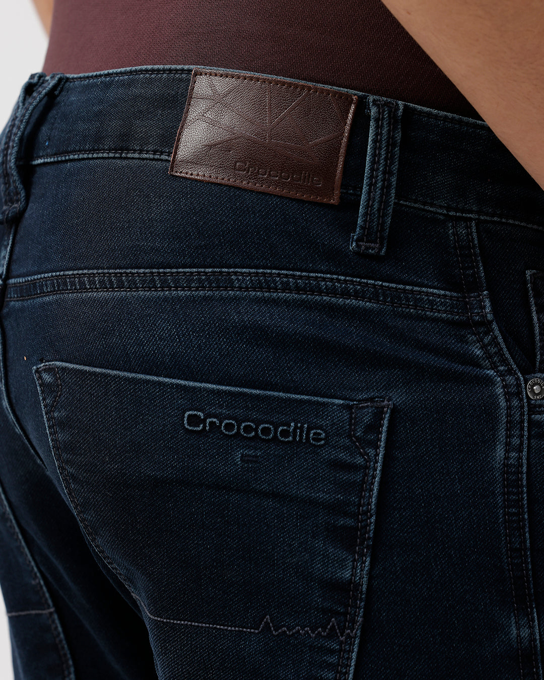 Dark blue jeans with a leather patch and 'Crocodile' branding on the back pocket.
