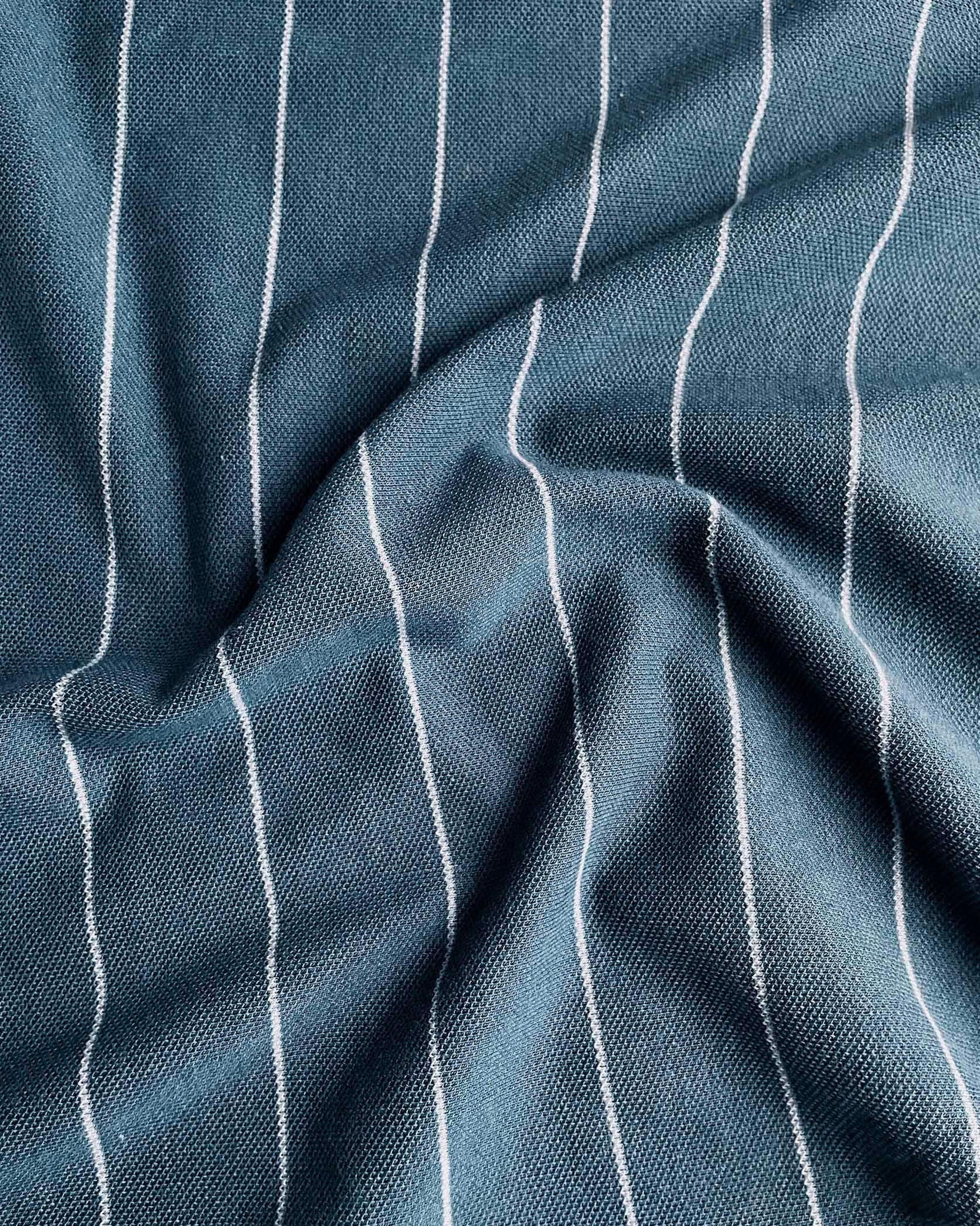 Close-up of blue fabric with white pinstripes