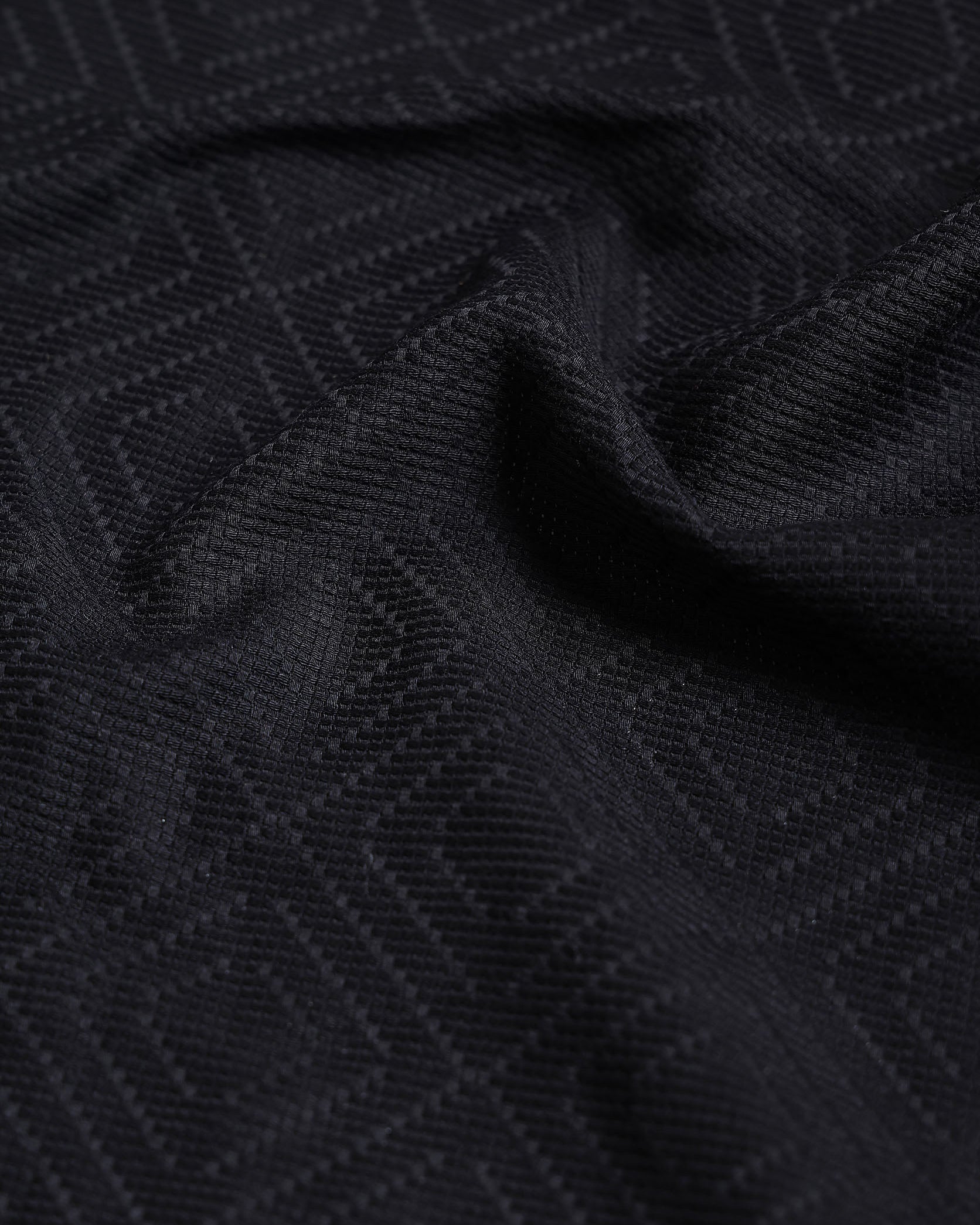 Close-up of black textured fabric with geometric pattern