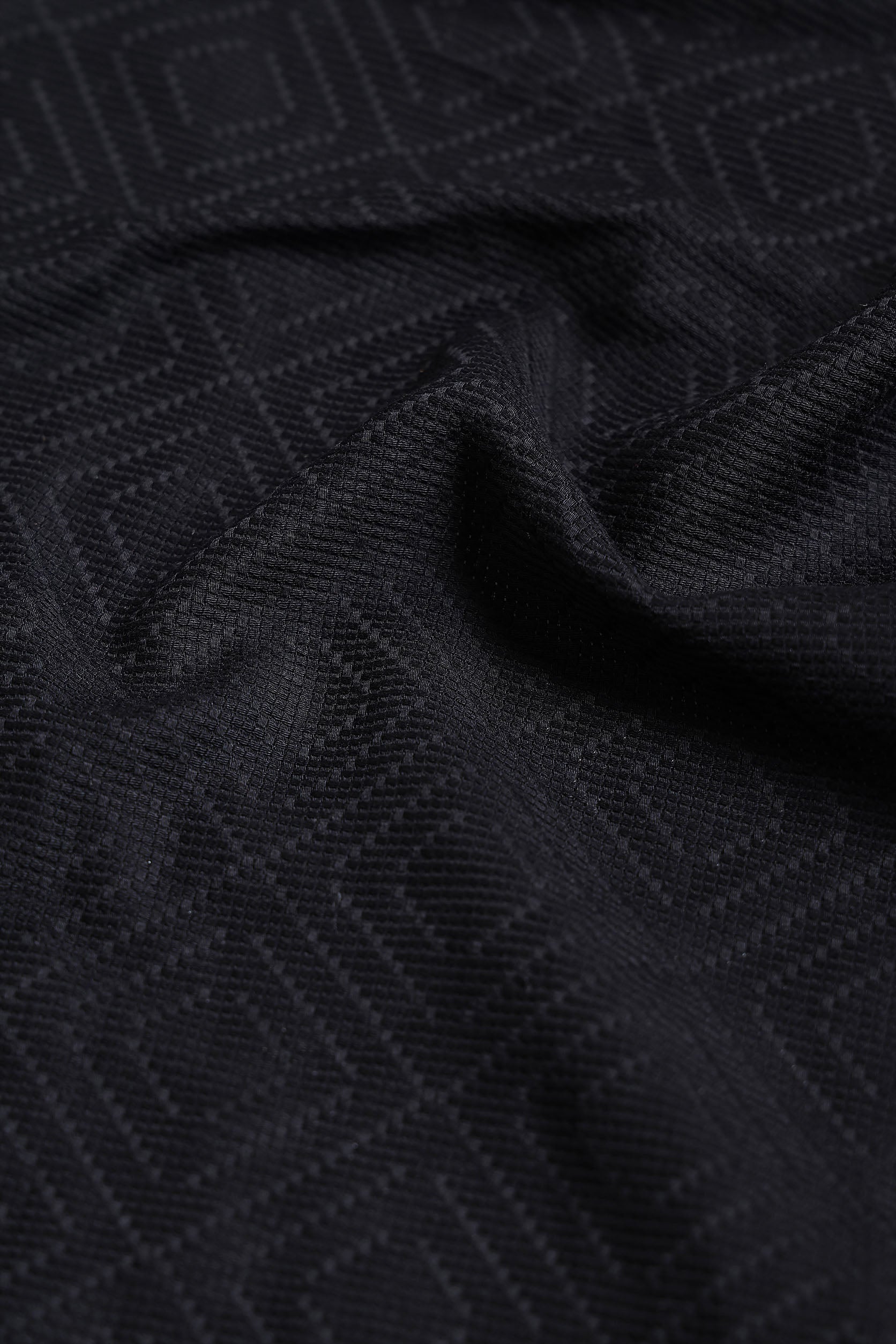 Close-up of black textured fabric with geometric pattern