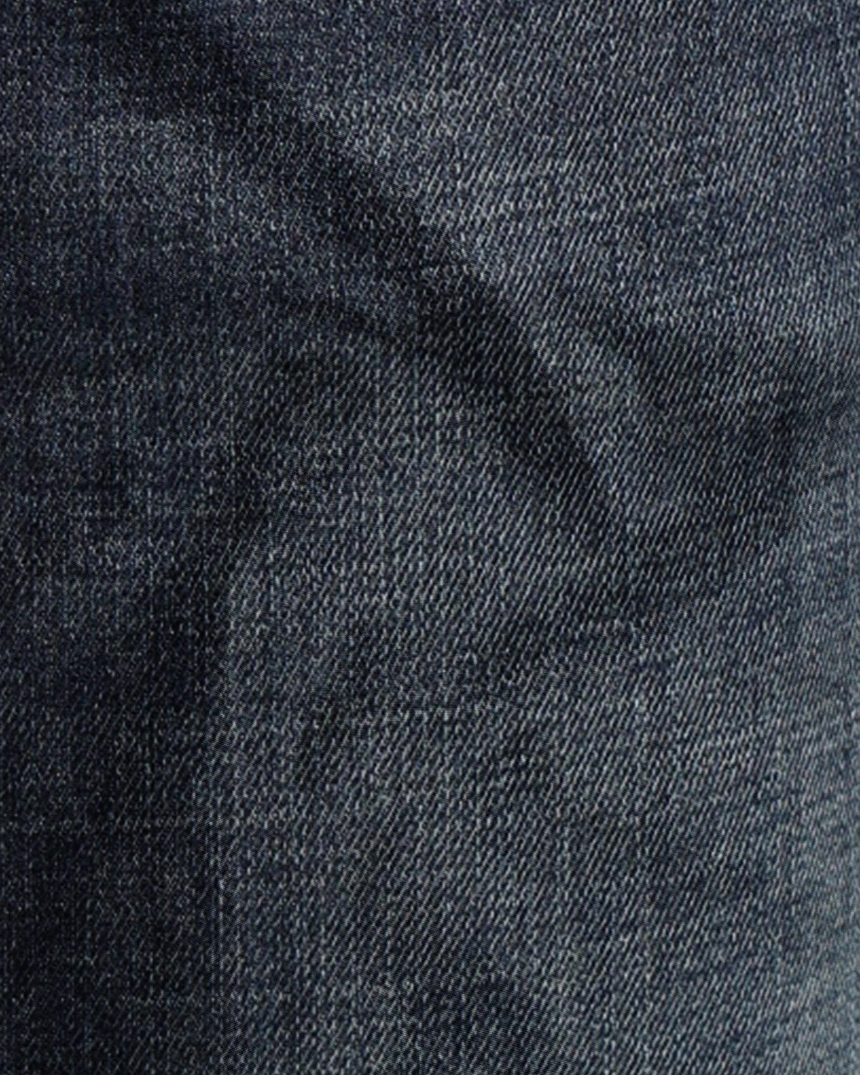 Close-up of dark blue denim fabric with a subtle pattern