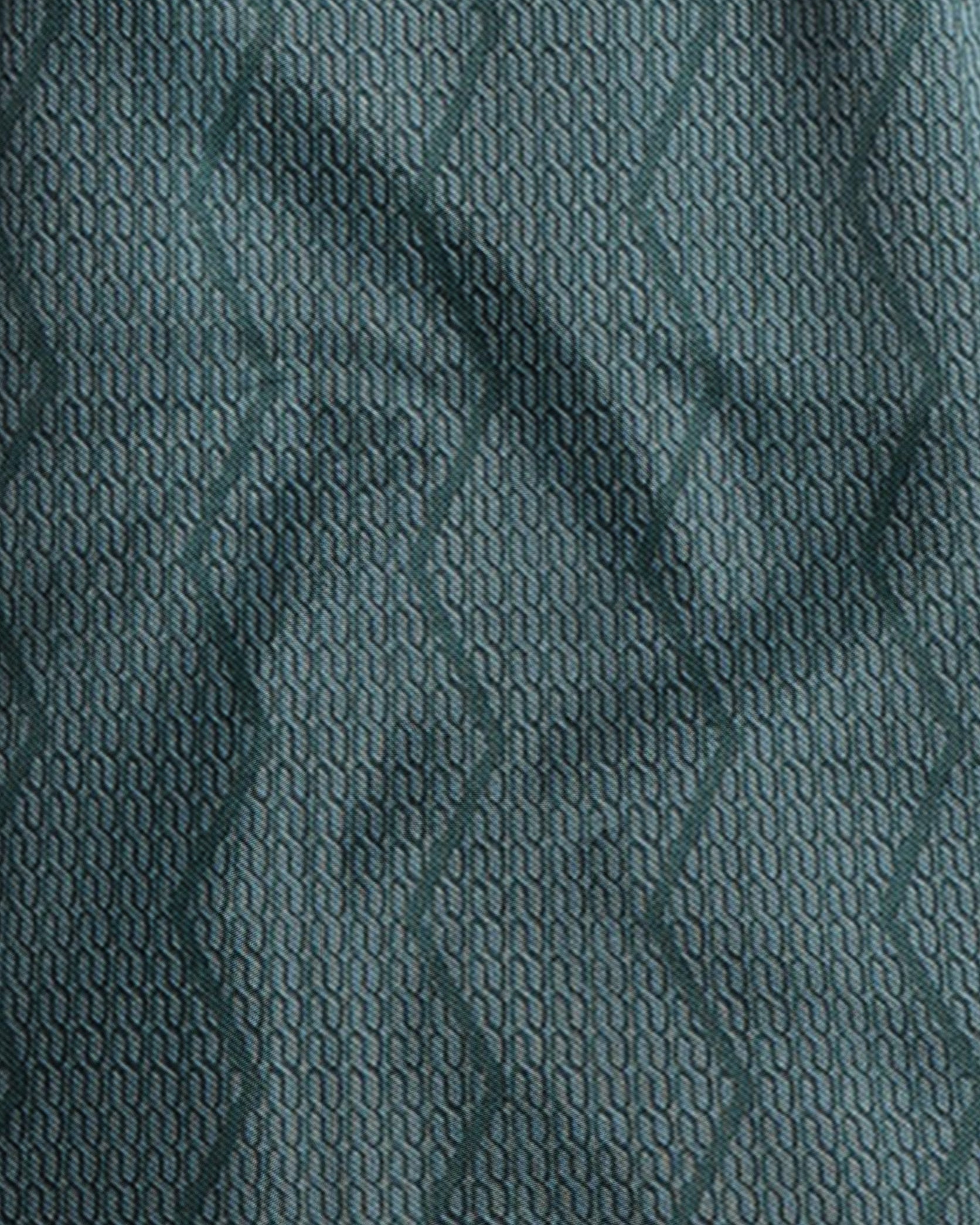 Close-up of textured teal fabric with a subtle pattern