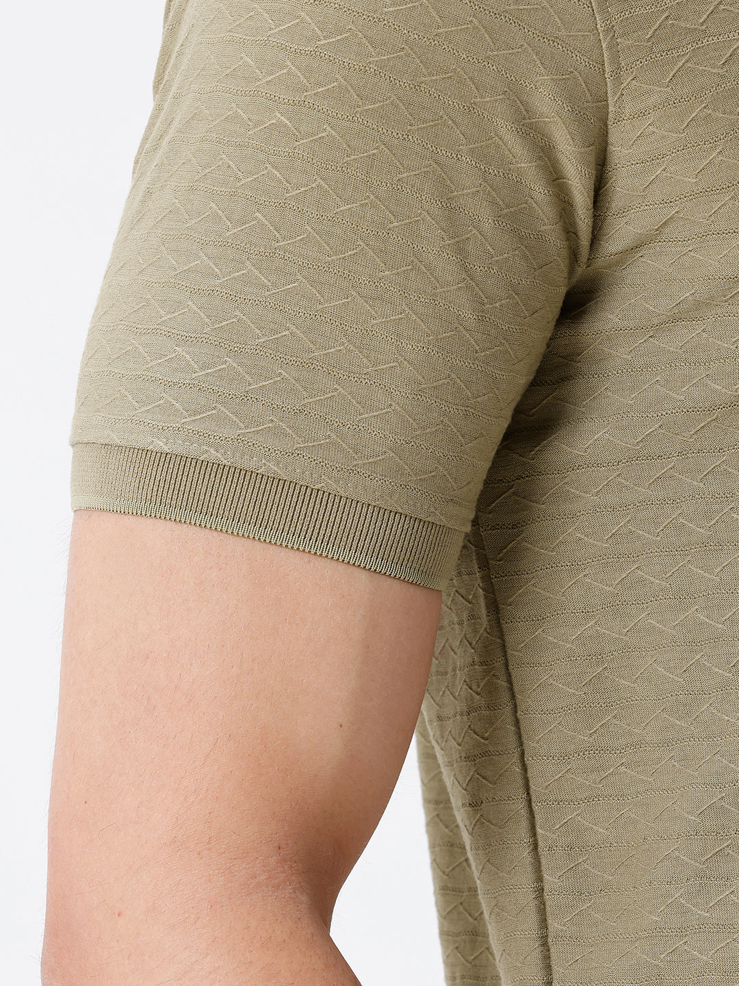 Man wearing a olive light olive structure comfort fit polo t shirt on a light gray background