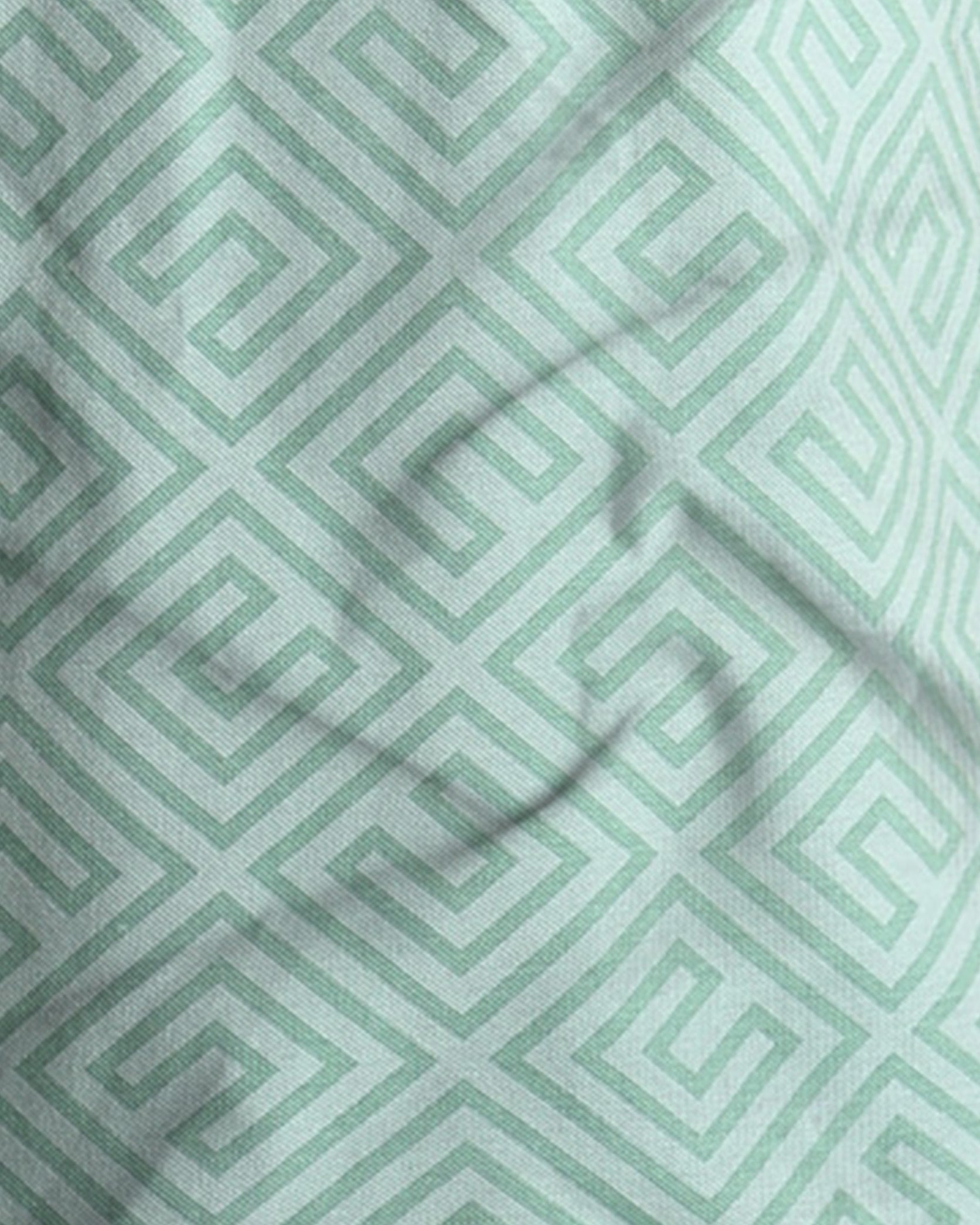 Close-up of a fabric with a green geometric pattern
