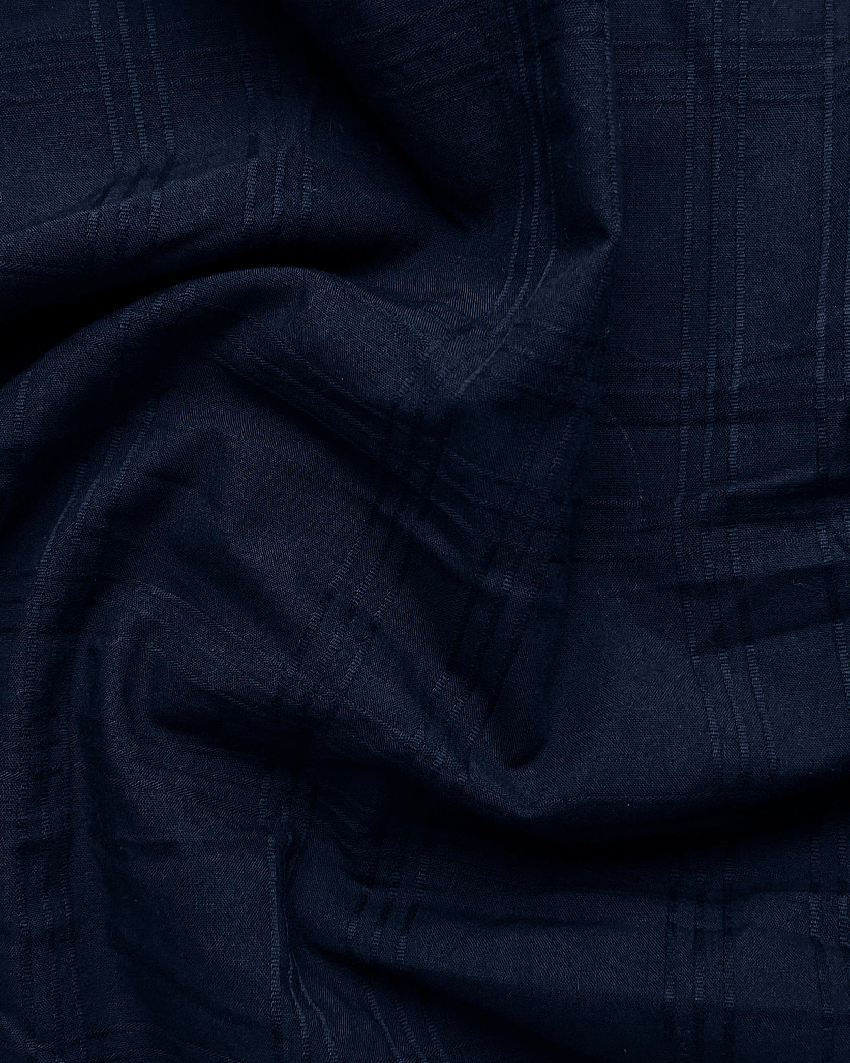 Close-up of dark blue fabric with a textured pattern