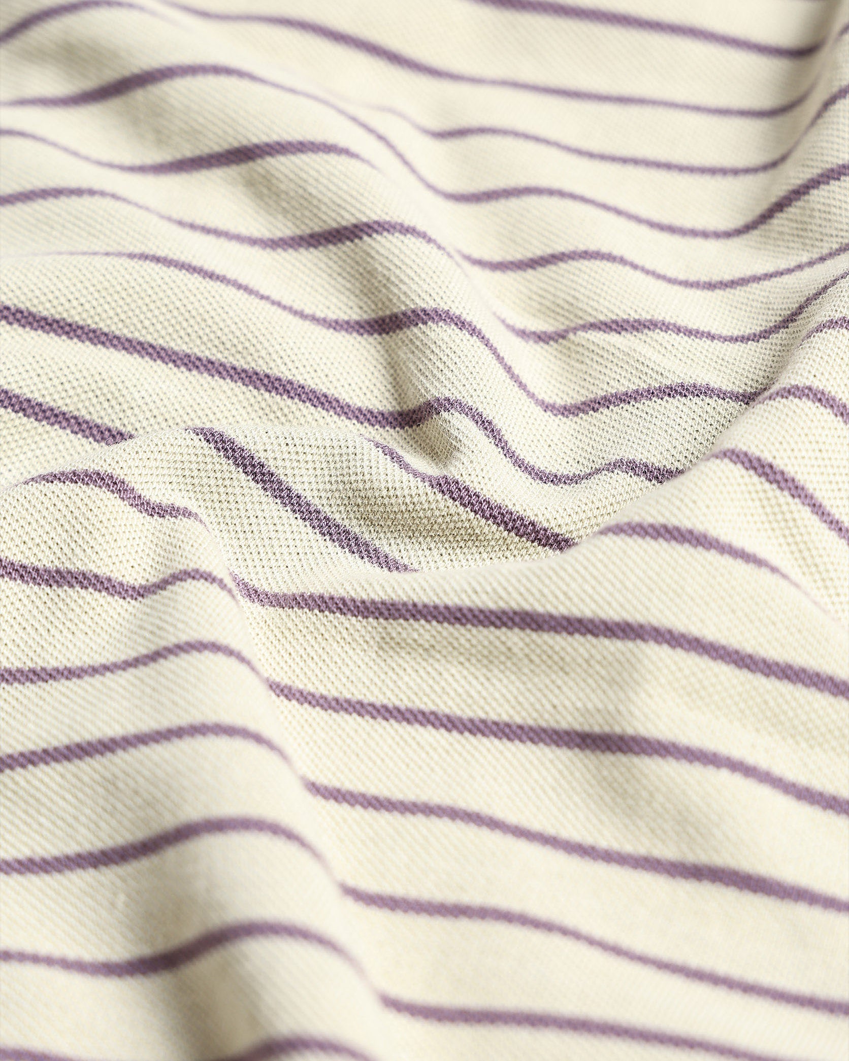 Close-up of fabric with purple stripes on a white background