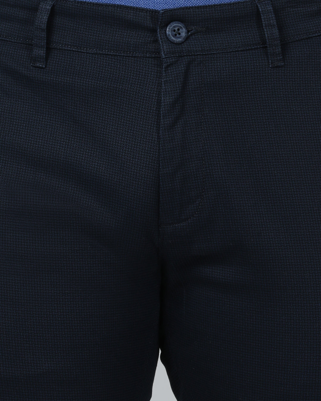 Man wearing a navy navy casual printed trouser with casual styling on a gray background