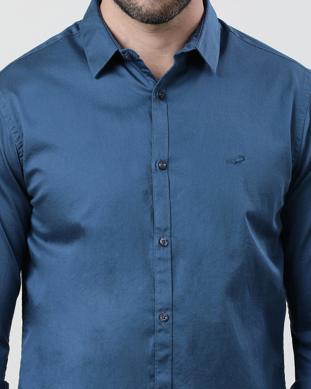 Man wearing a blue royal blue solid full sleeve 100% cotton shirt with casual styling on a gray background