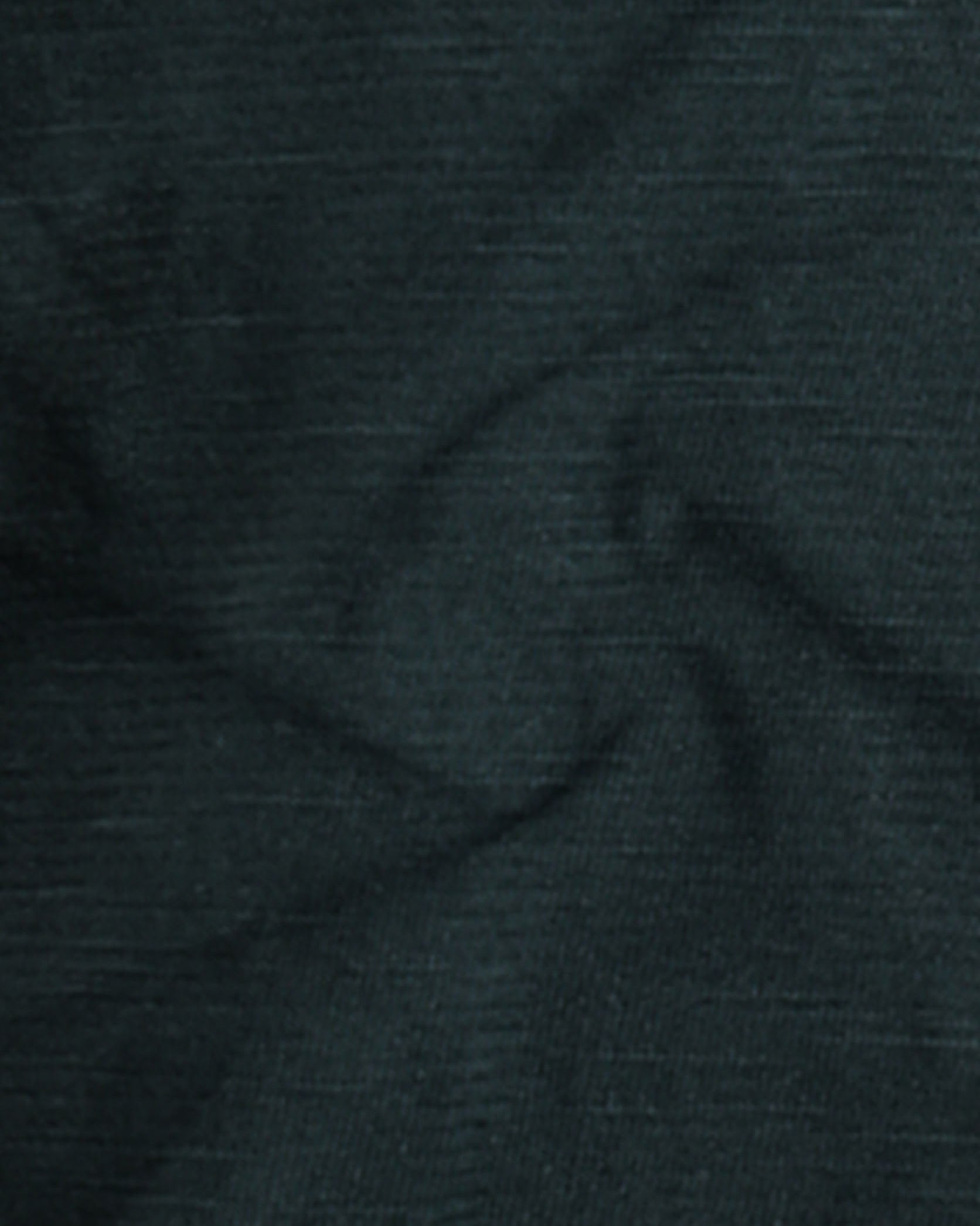 Close-up of dark green fabric texture