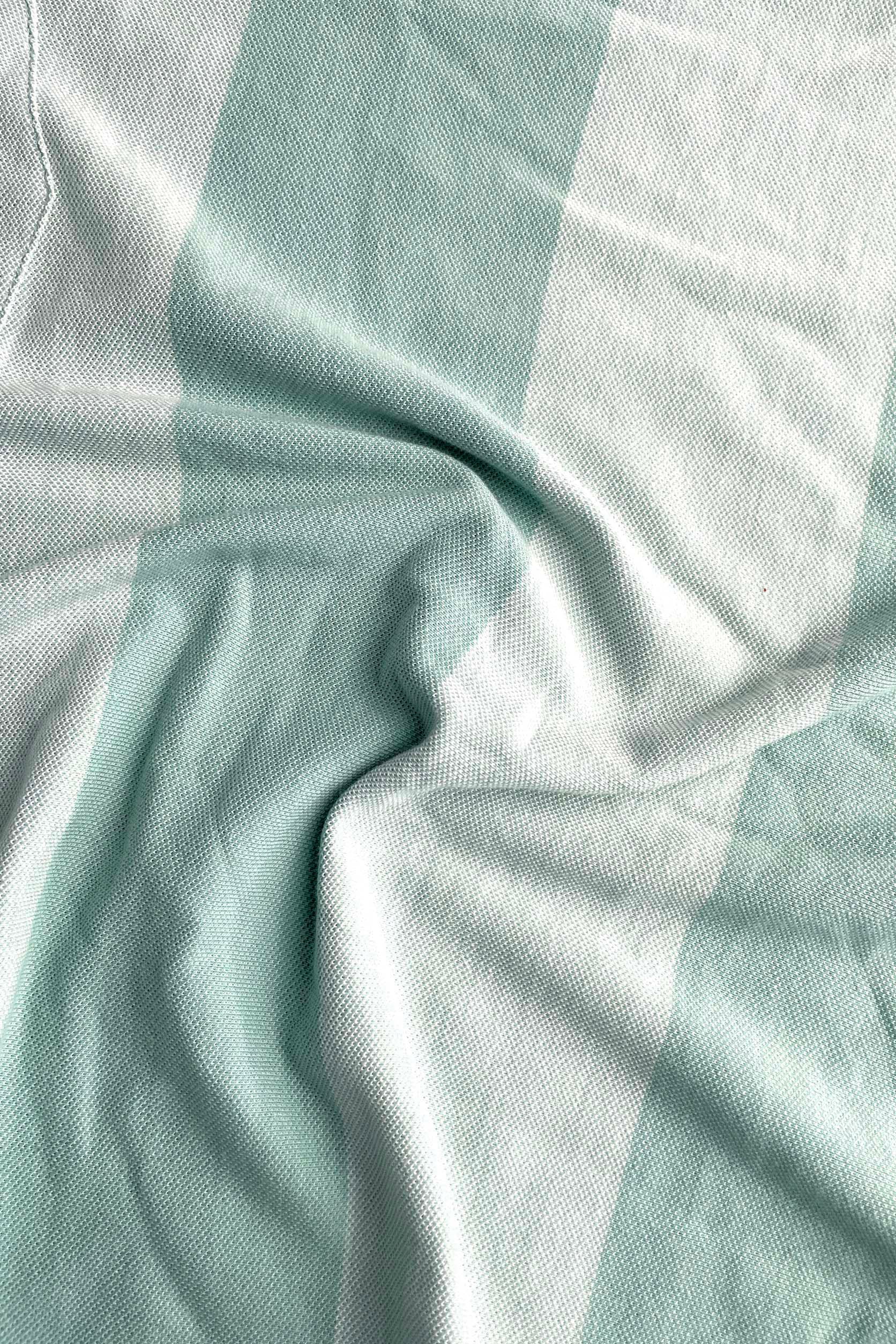 Close-up of light blue fabric with a checkered pattern