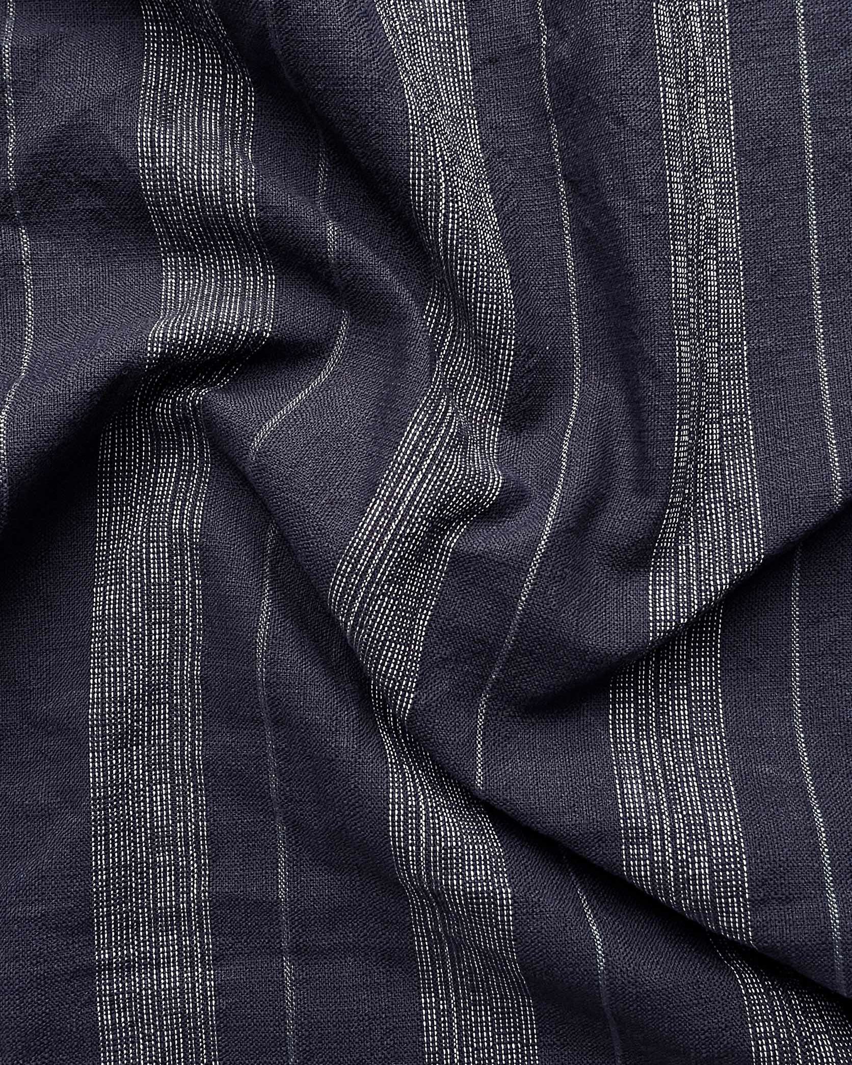 Close-up of dark blue fabric with subtle pattern