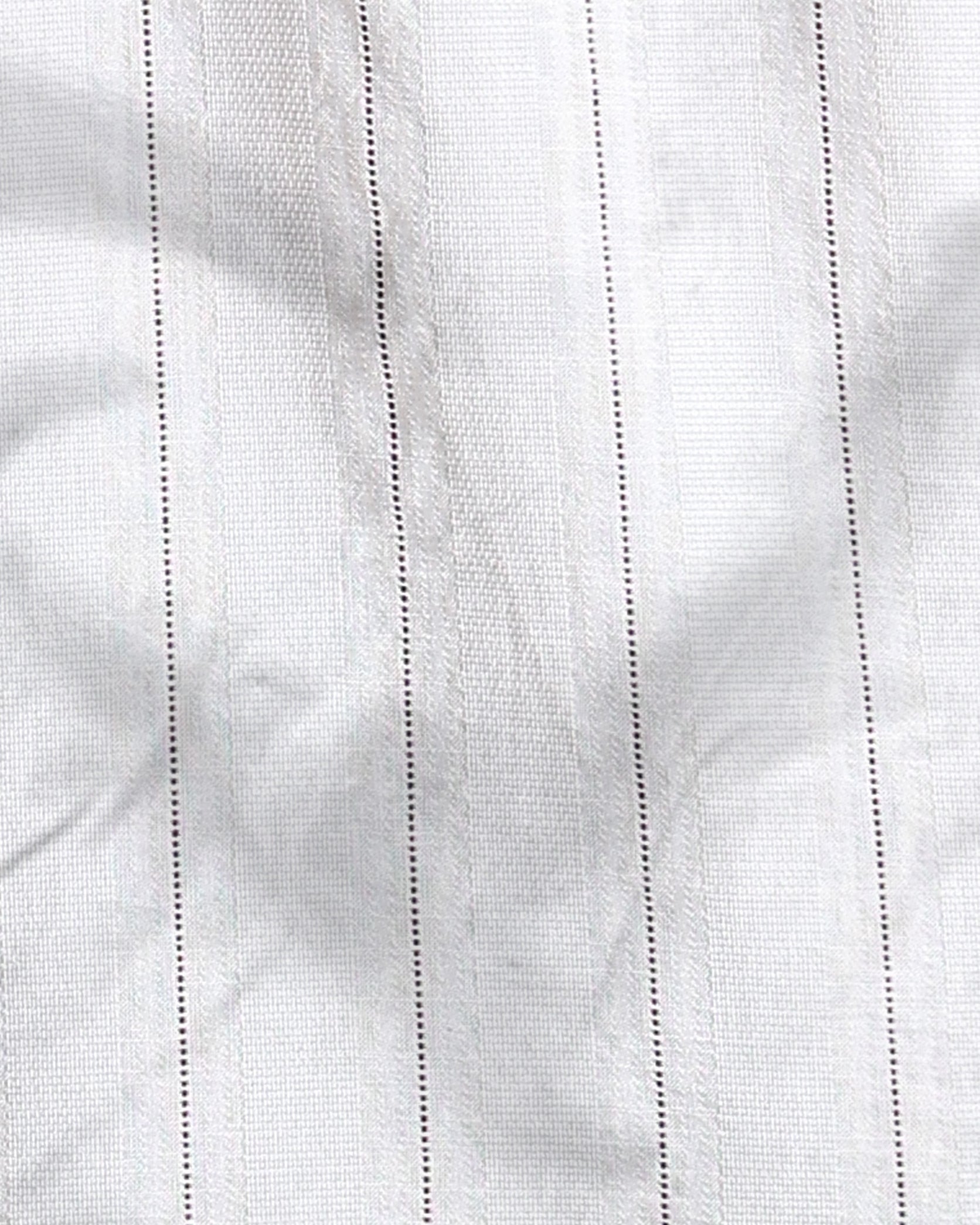 Close-up of white fabric with subtle texture and stitching details