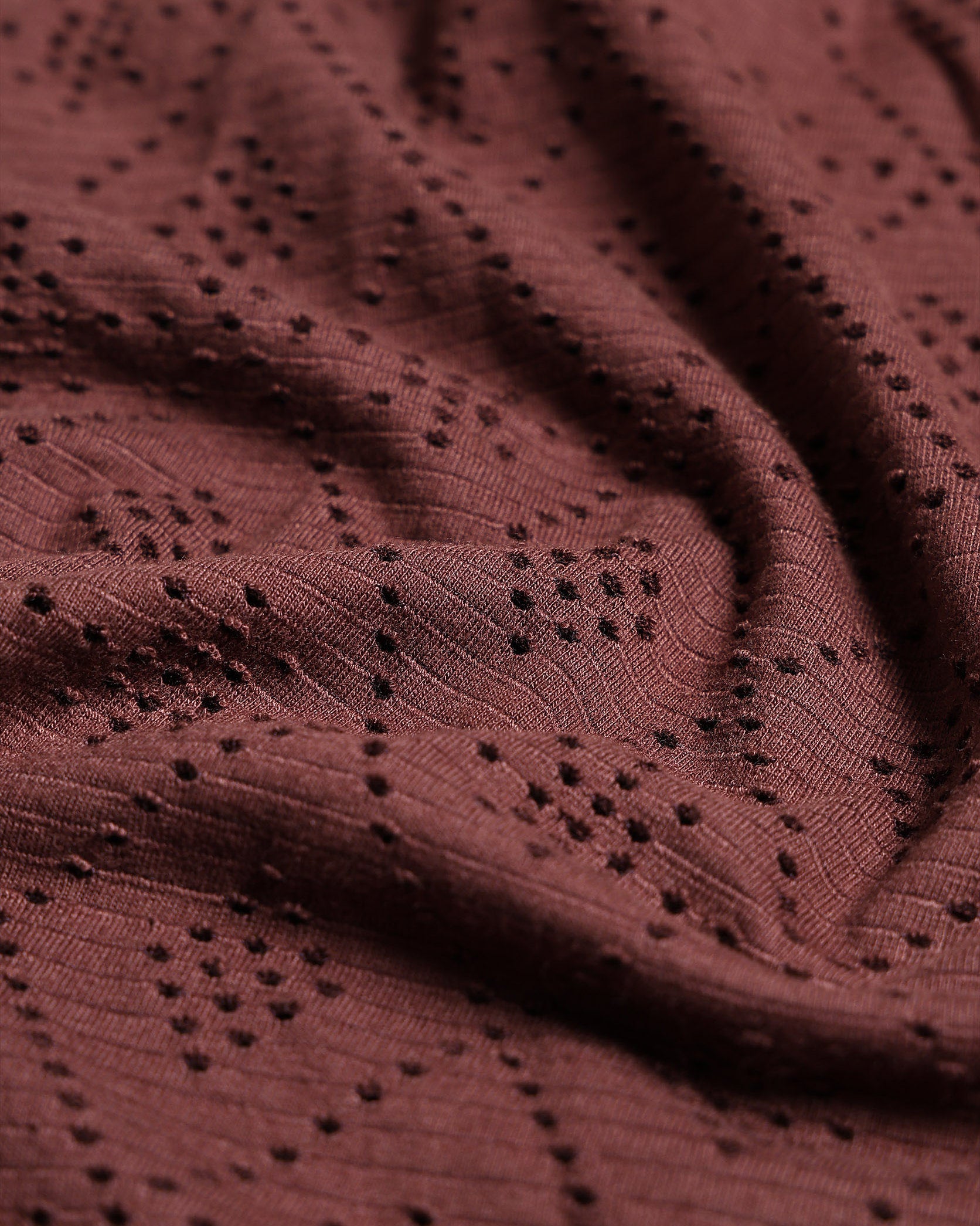 Close-up of a brown fabric with a subtle pattern