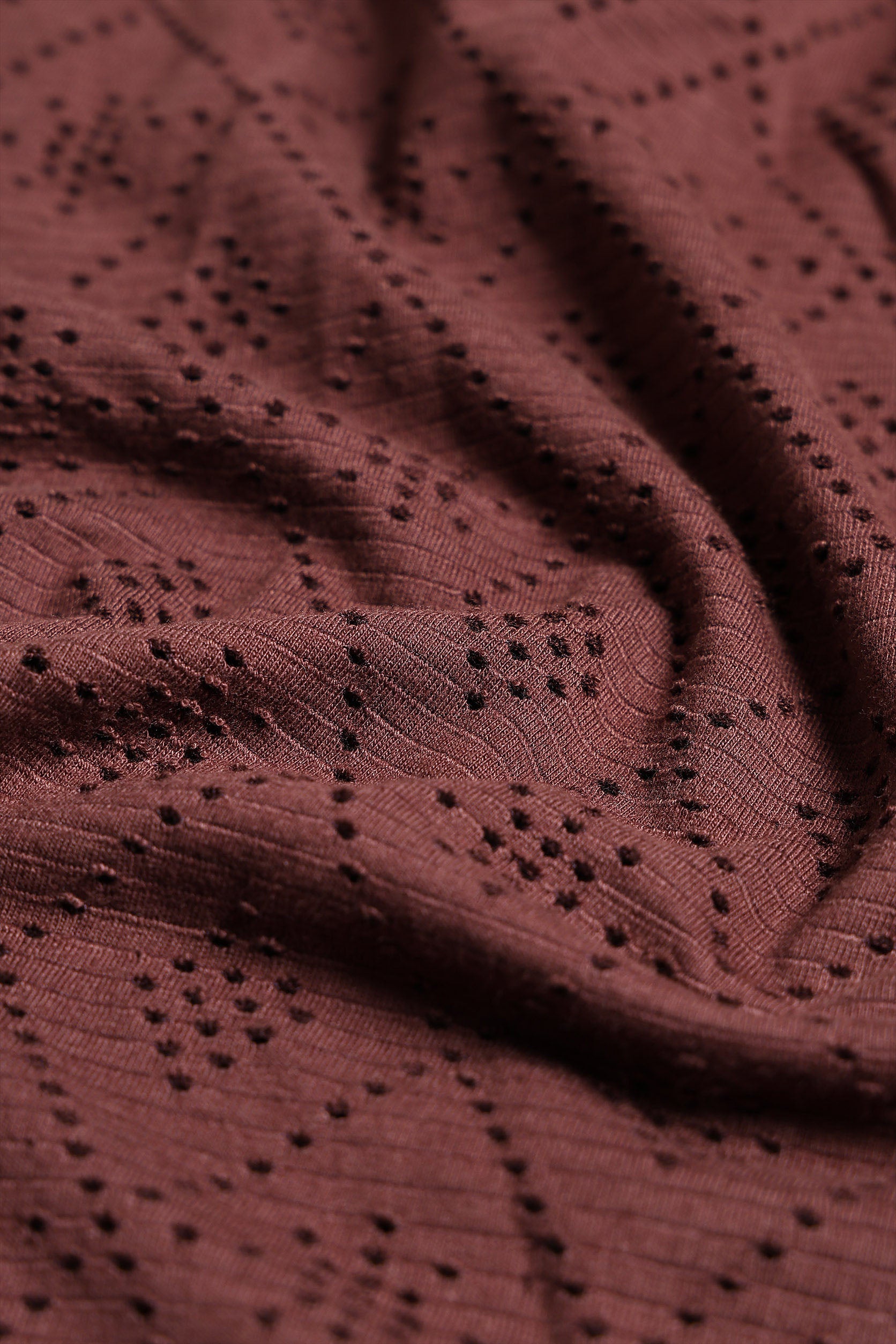 Close-up of a brown fabric with a subtle pattern