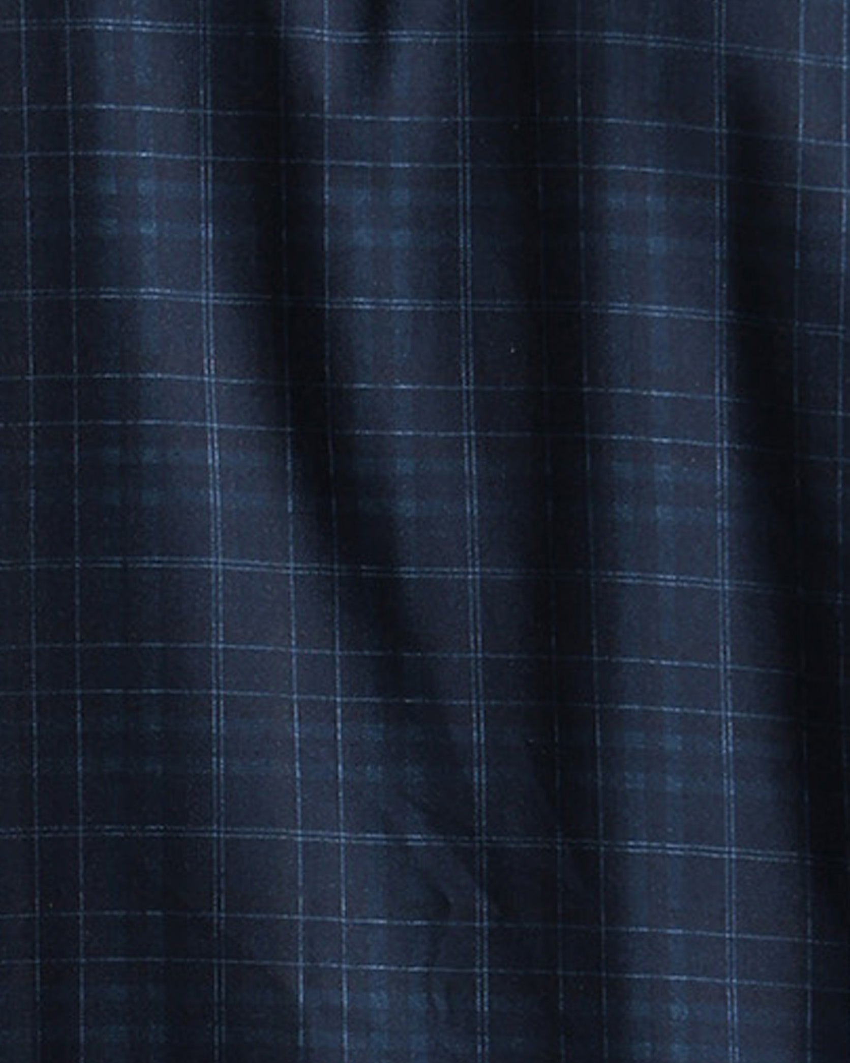 Close-up of dark blue fabric with a subtle check pattern
