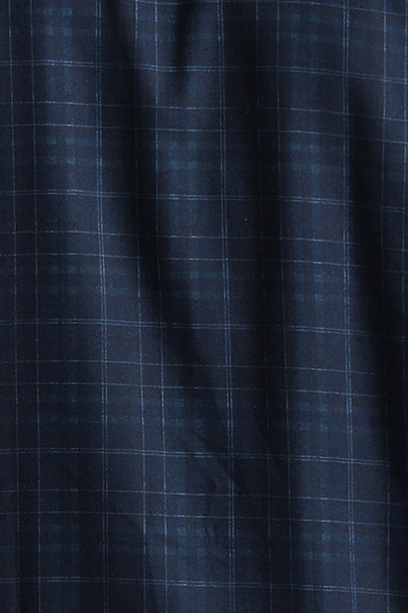Close-up of dark blue fabric with a subtle check pattern