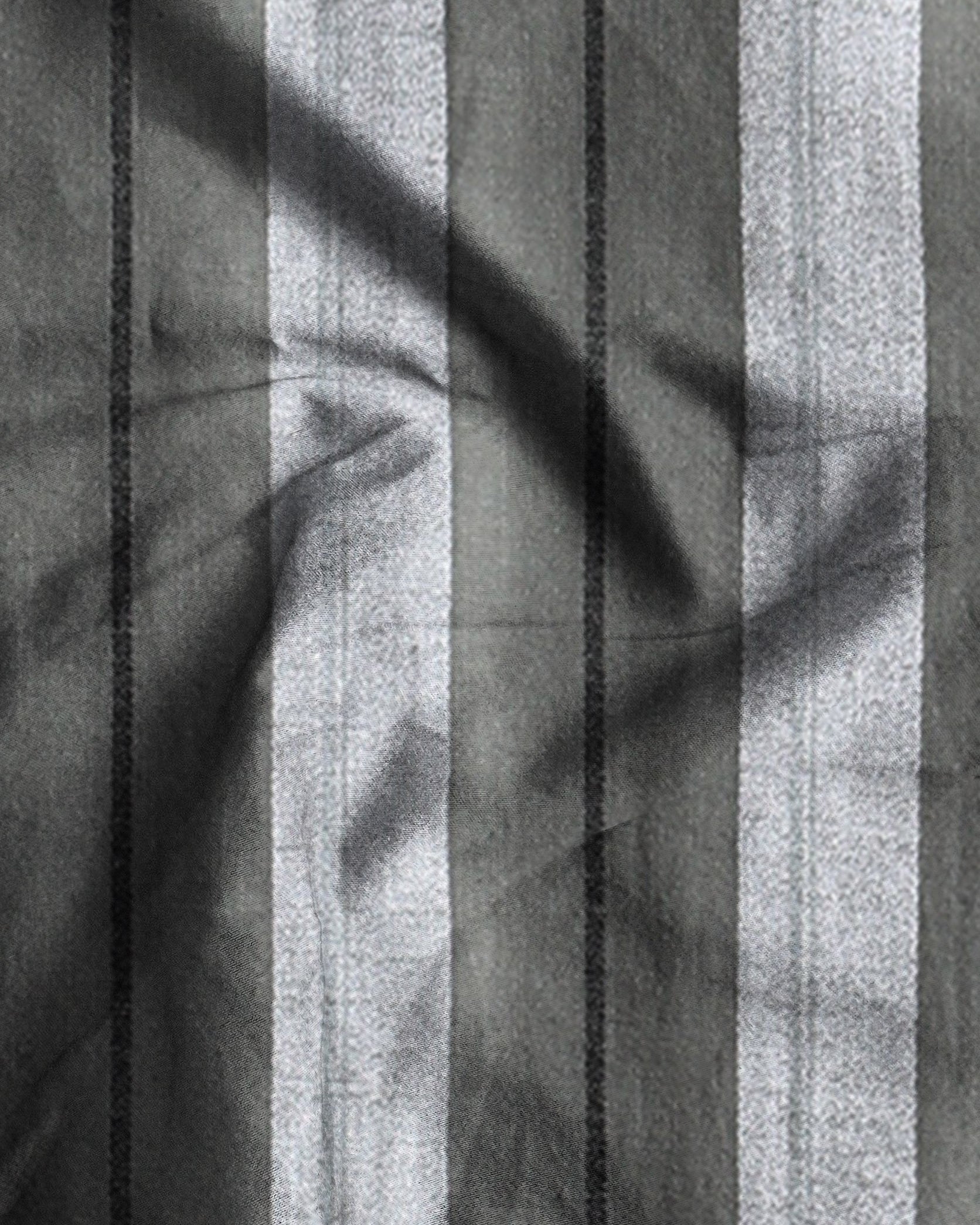 Black and white striped fabric with leaf shadows