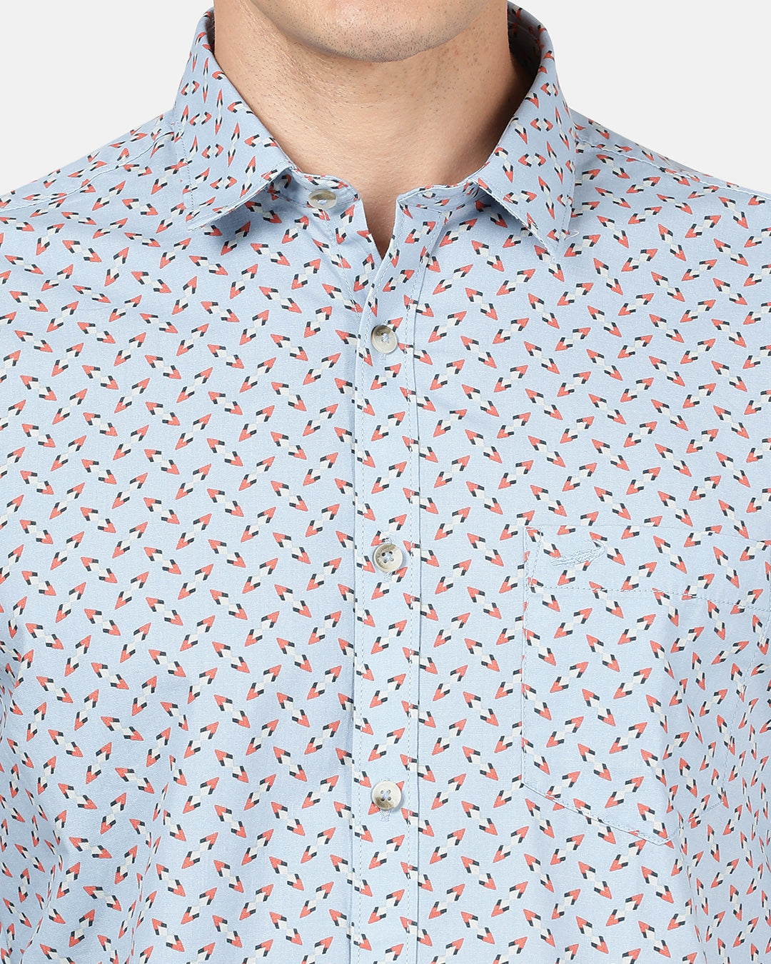 Man wearing a blue light blue printed full sleeve 100% cotton shirt on a light gray background