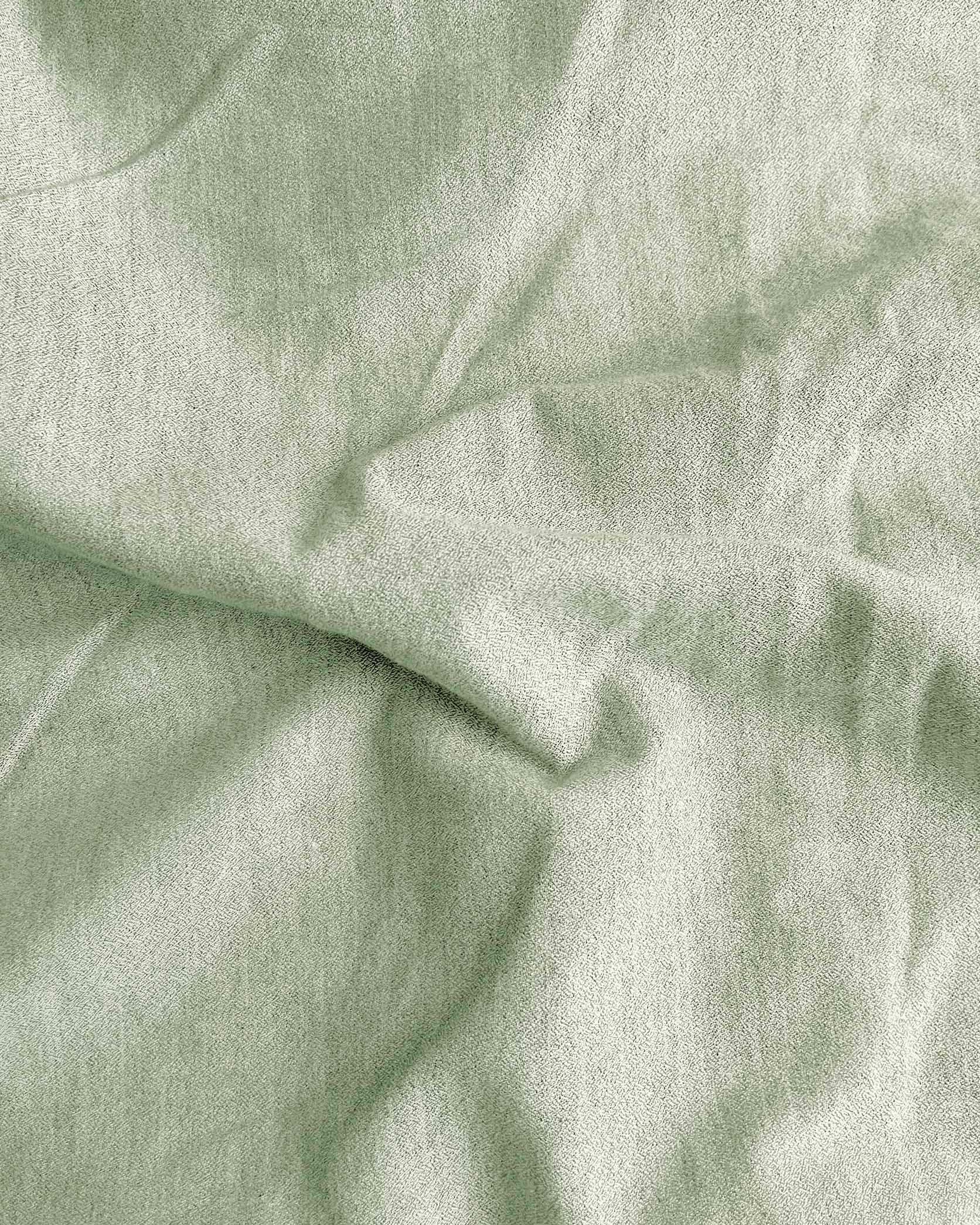 Close-up of light green fabric with folds
