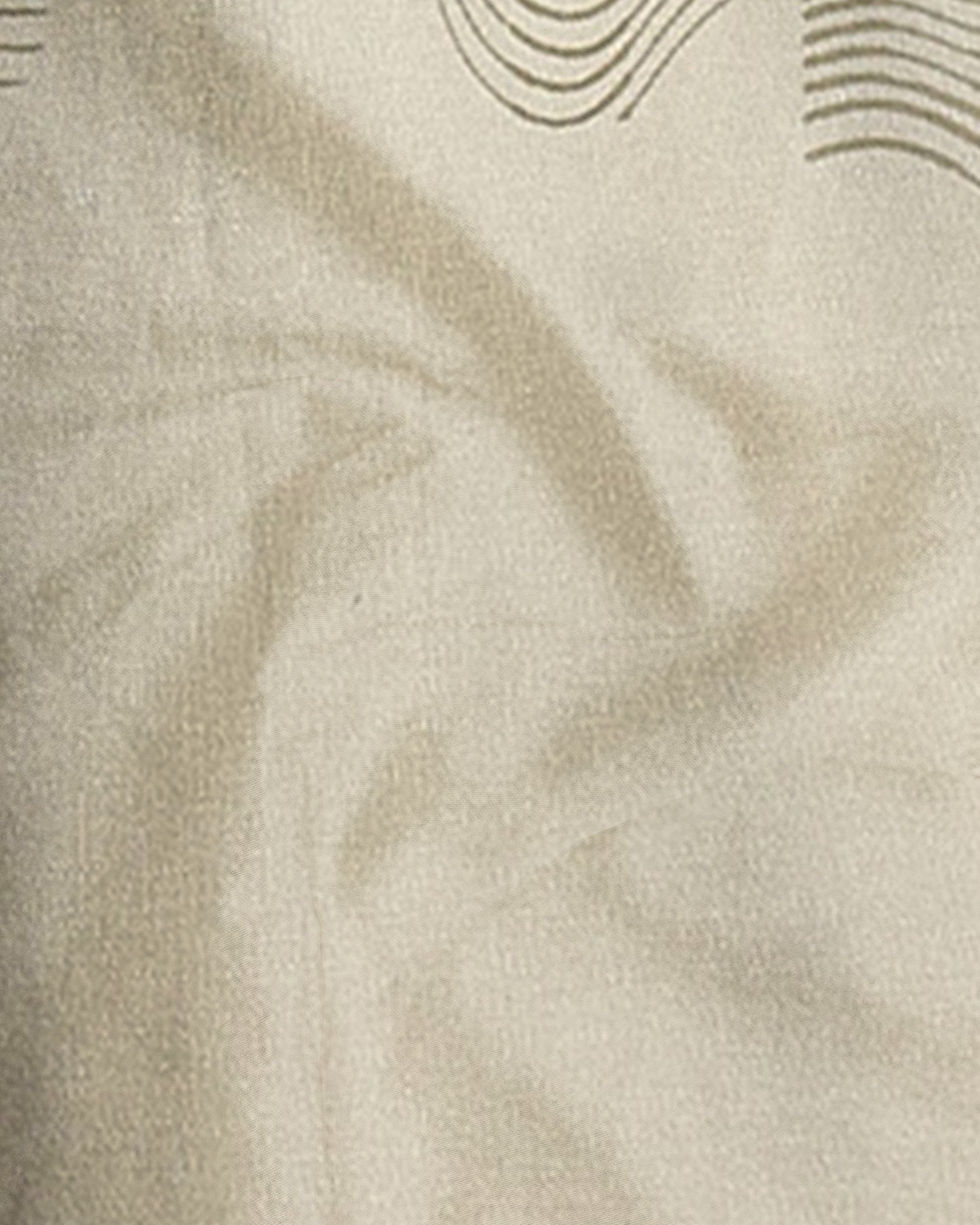 Close-up of beige fabric with subtle wave pattern
