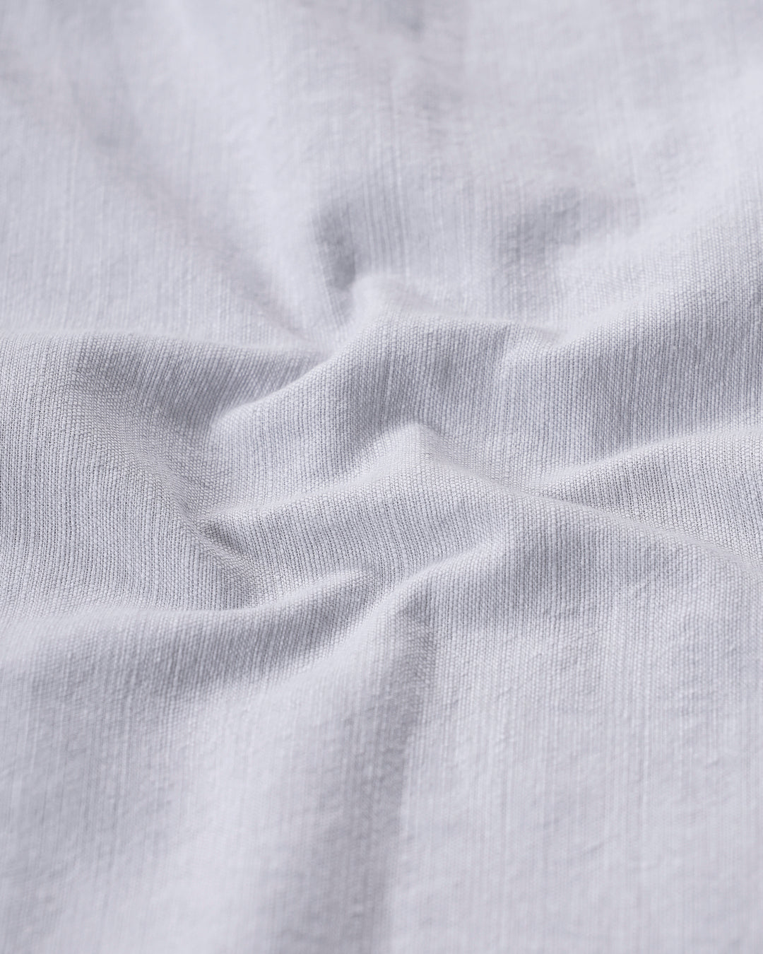 Man wearing a grey rib textured cotton shirt grey on a light gray background