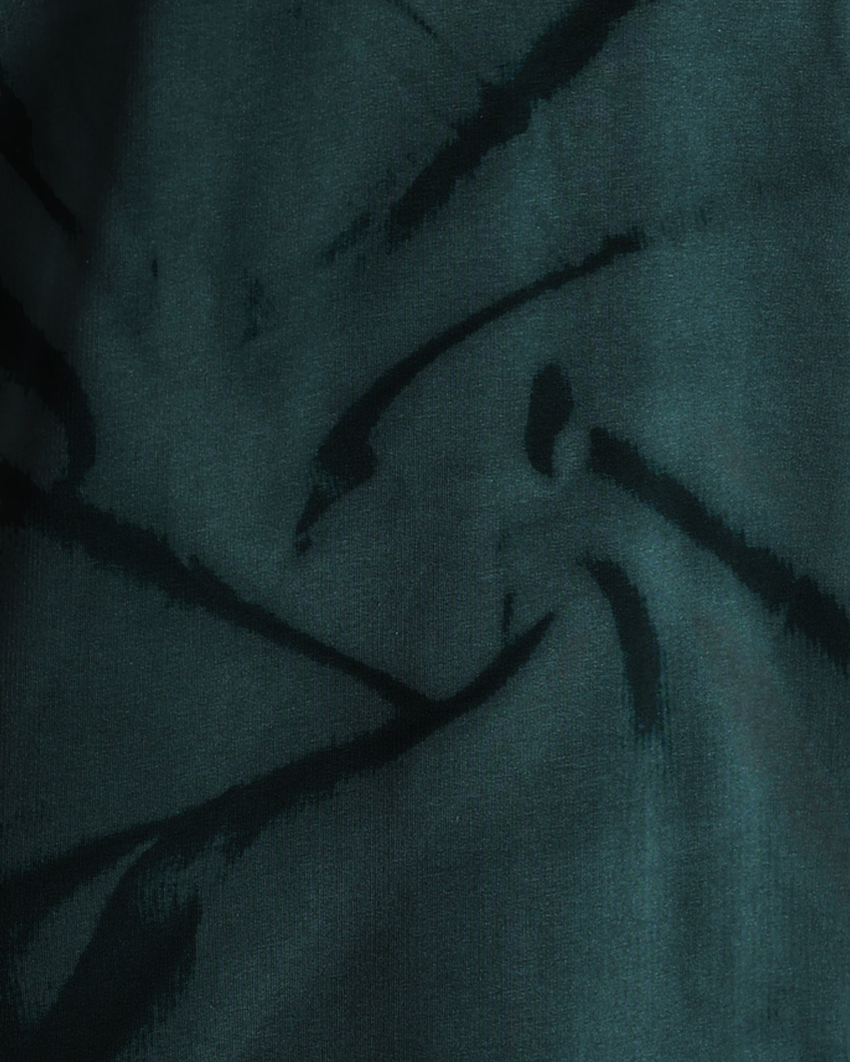 Dark fabric with feather-like patterns