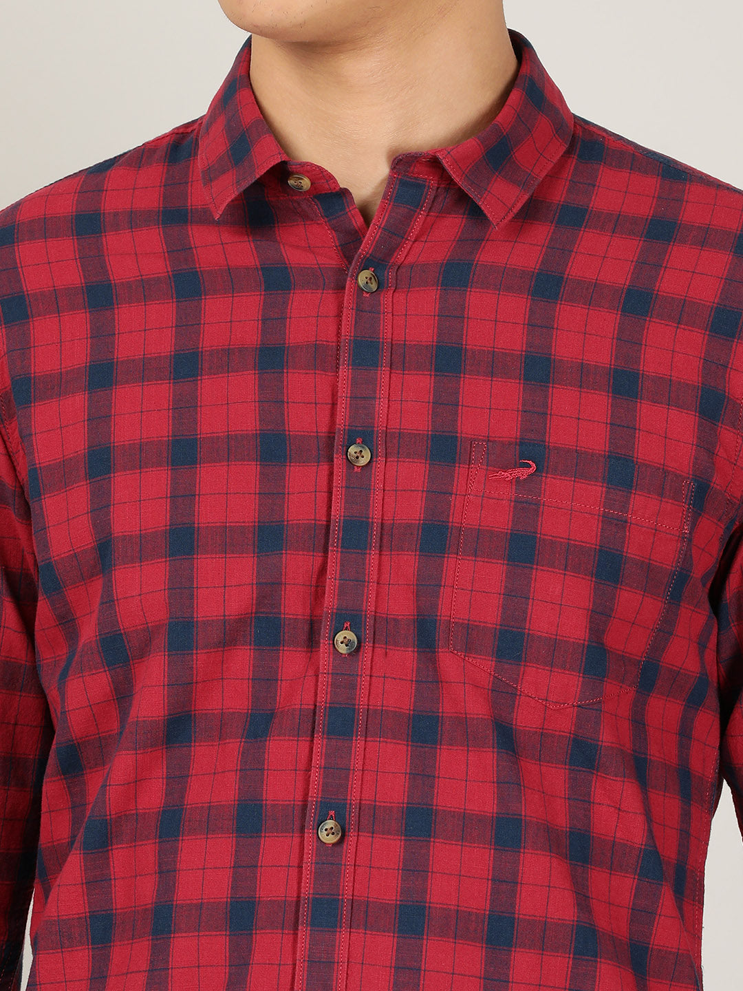 Man wearing a red red checked full sleeve 100% cotton casual shirt on a light gray background