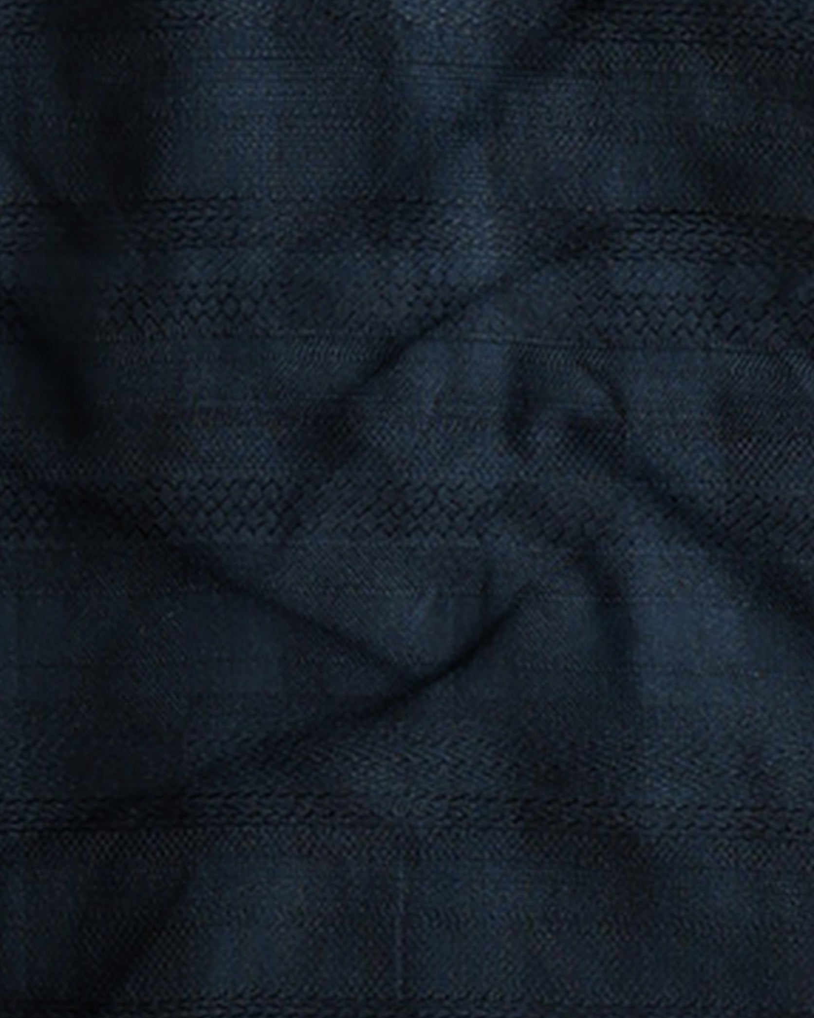 Close-up of dark blue fabric with a subtle pattern