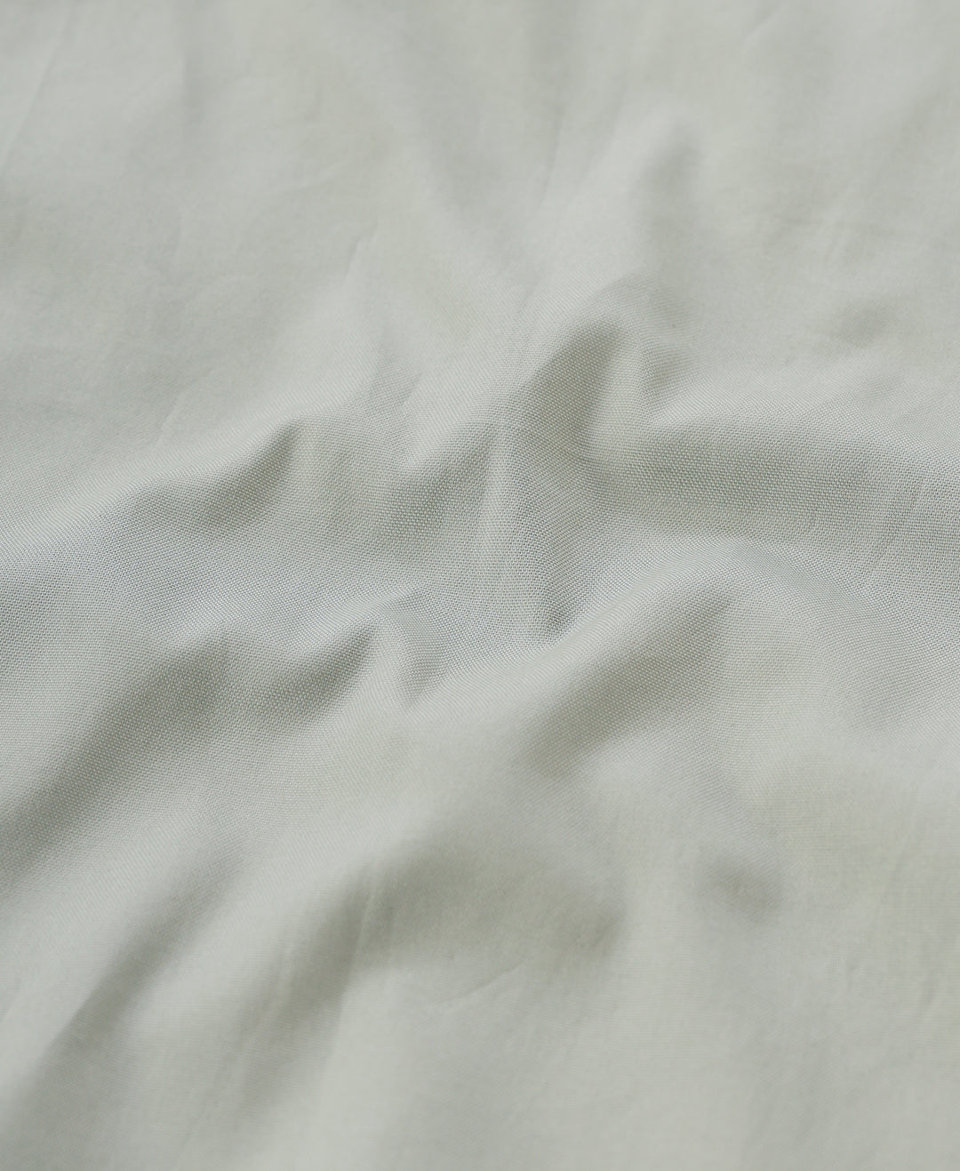 Man wearing a green smart series premium oxford shirt green with casual styling on a gray background