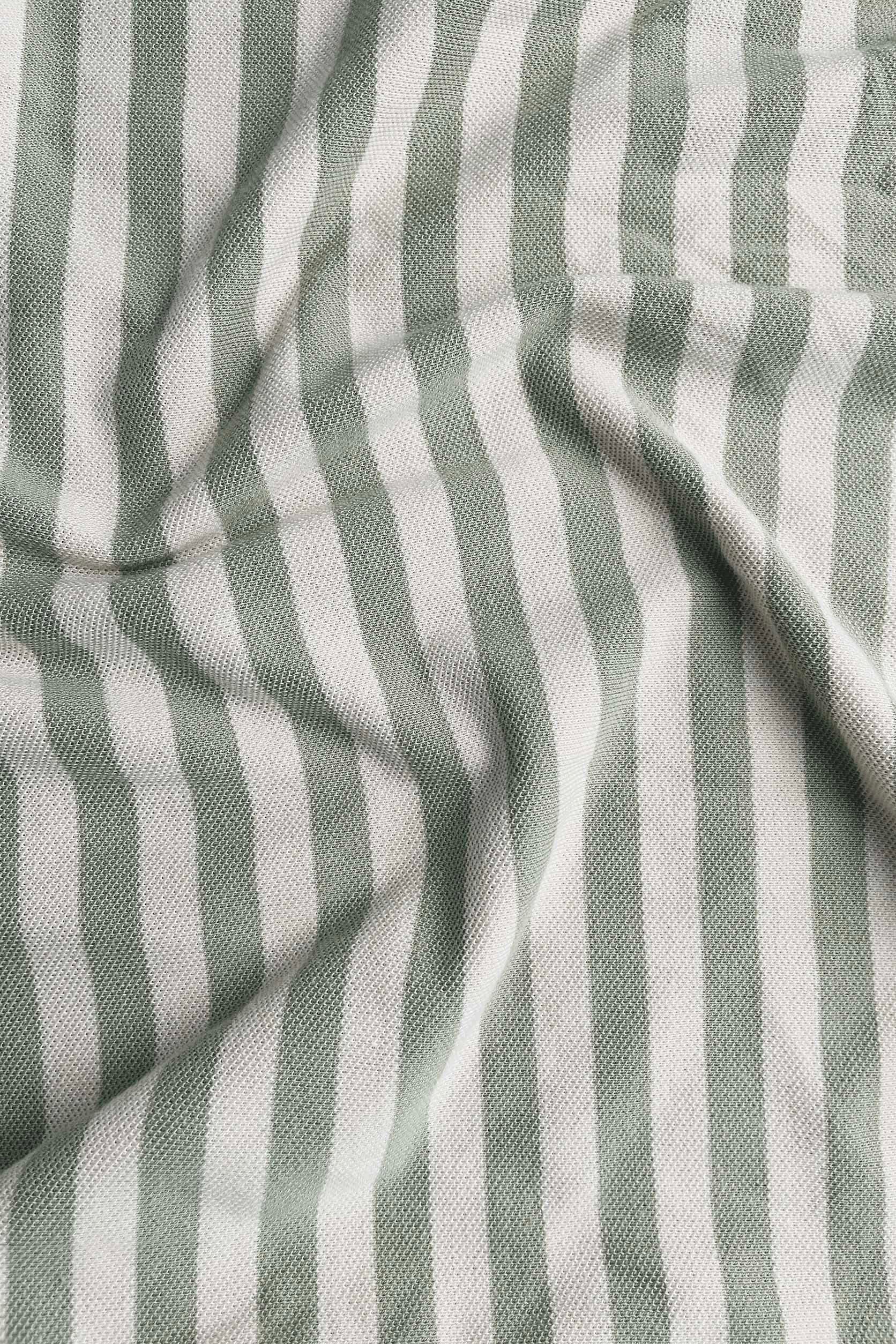 Close-up of striped fabric with alternating light and dark gray stripes.