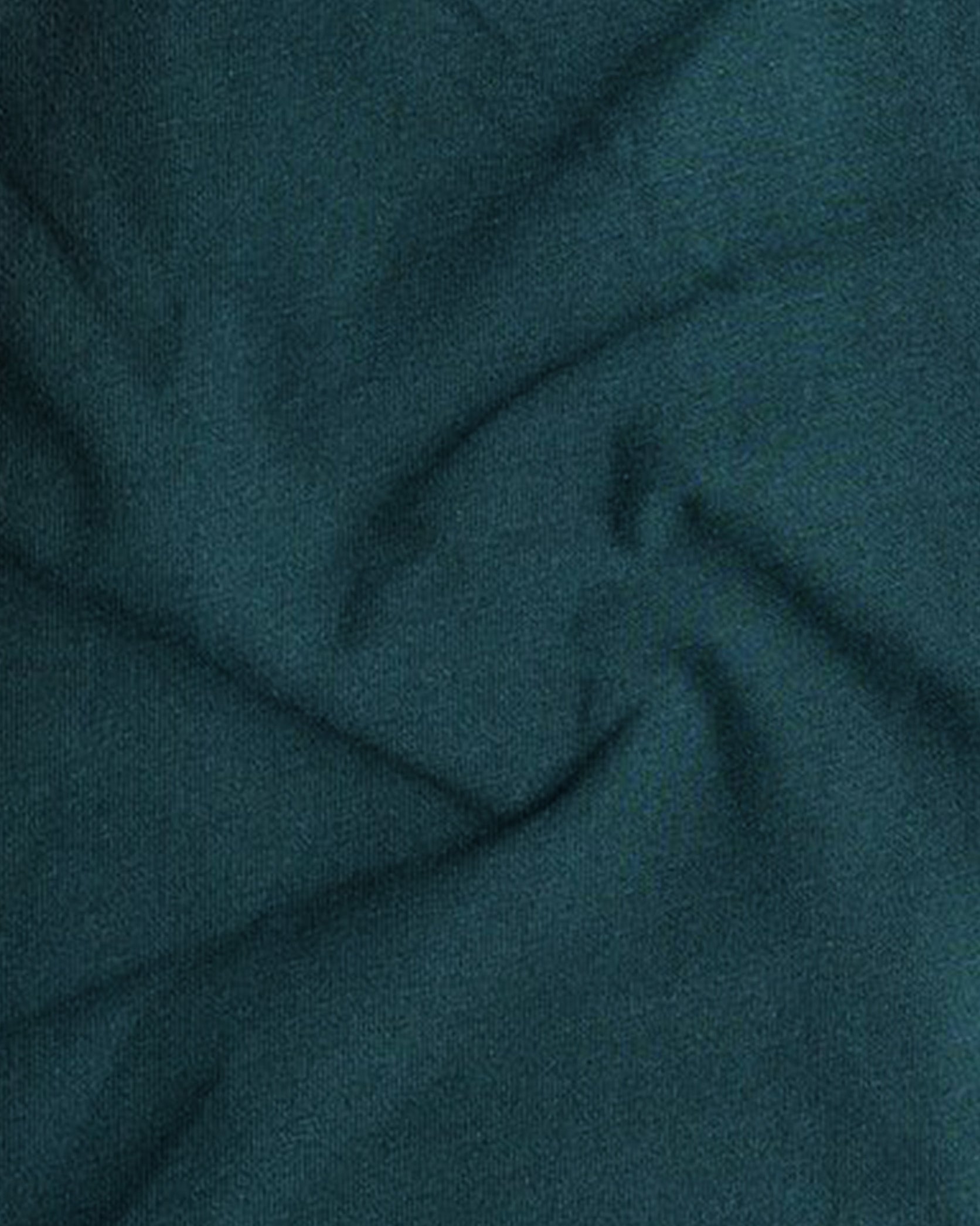 Close-up of teal fabric with folds