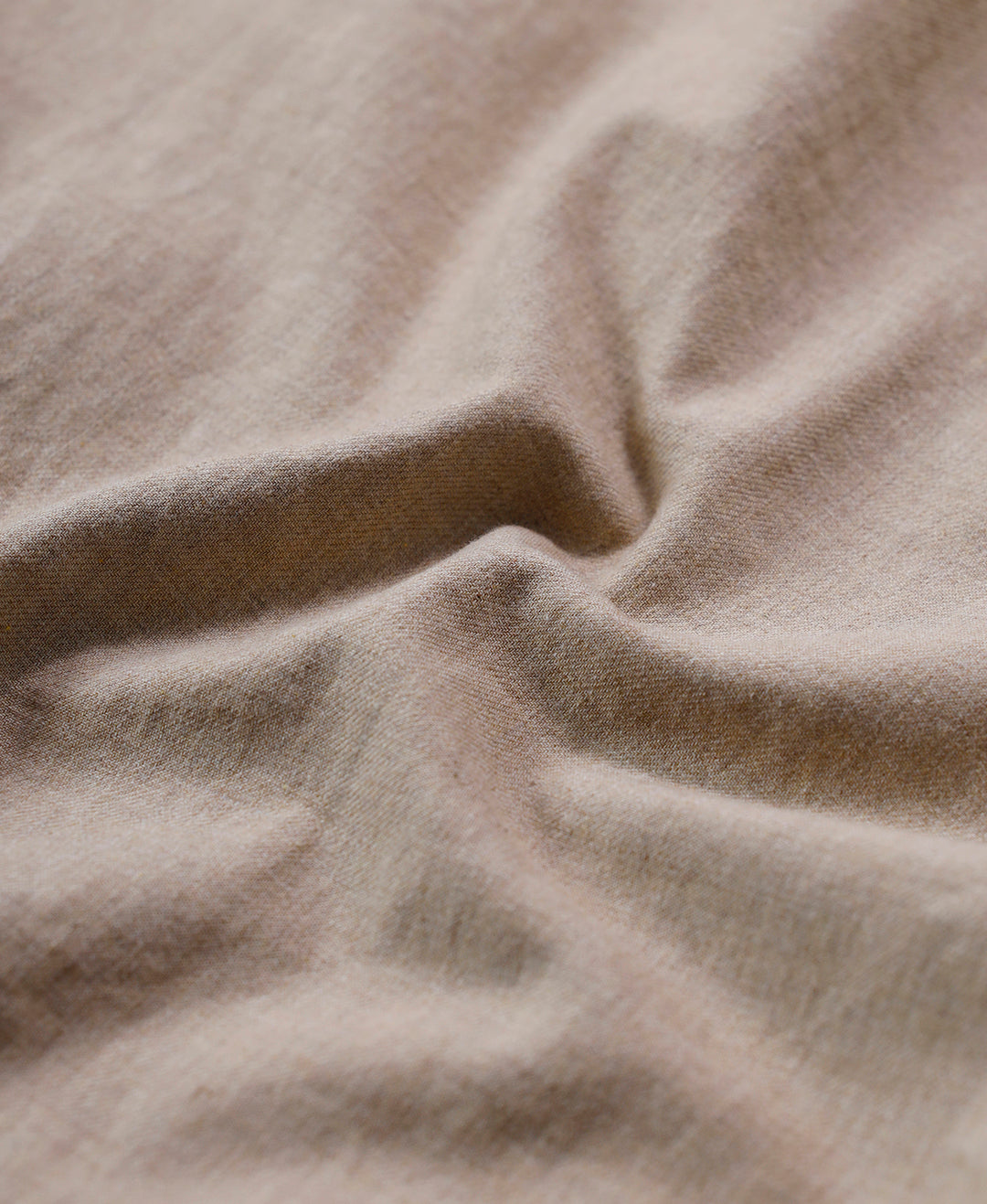 Man wearing a beige melange shirt solid beige on a light gray background