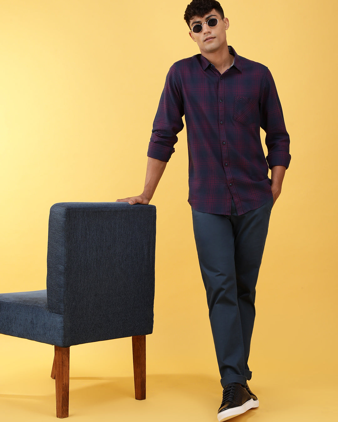 Man wearing a pink dark pink checked full sleeve 100% cotton shirt on a light gray background