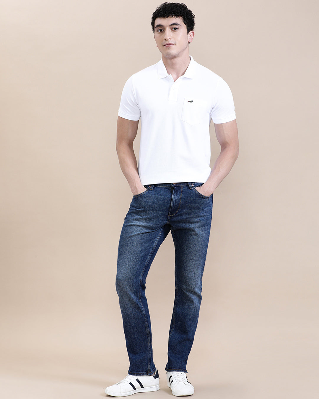 Man wearing a white white solid polo t shirt with pocket with casual styling on a gray background