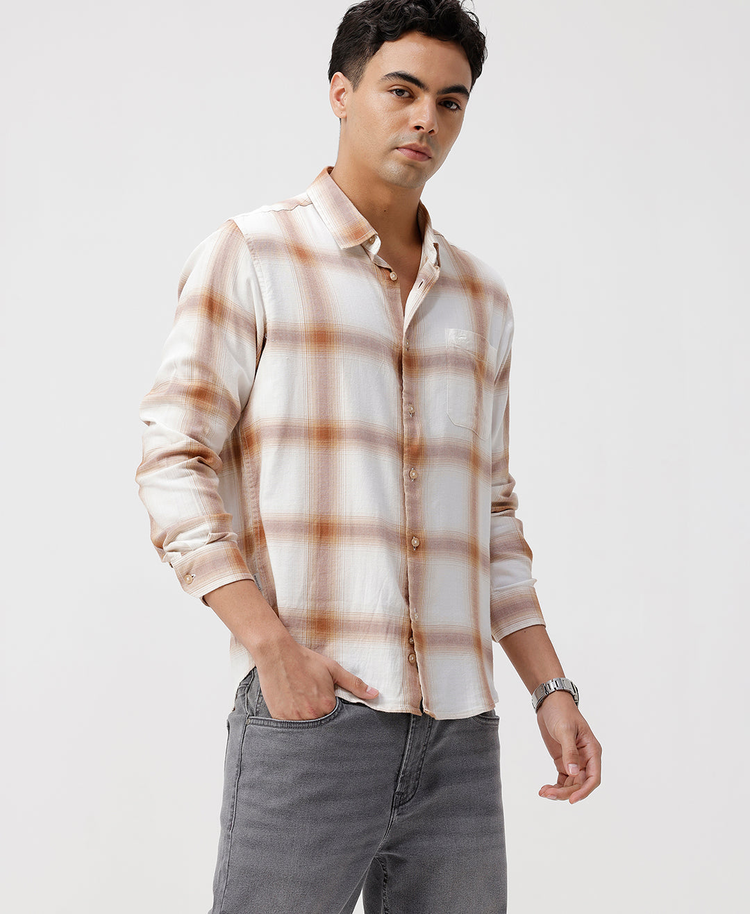 Man wearing a red textured grunge print shirt with casual styling on a gray background