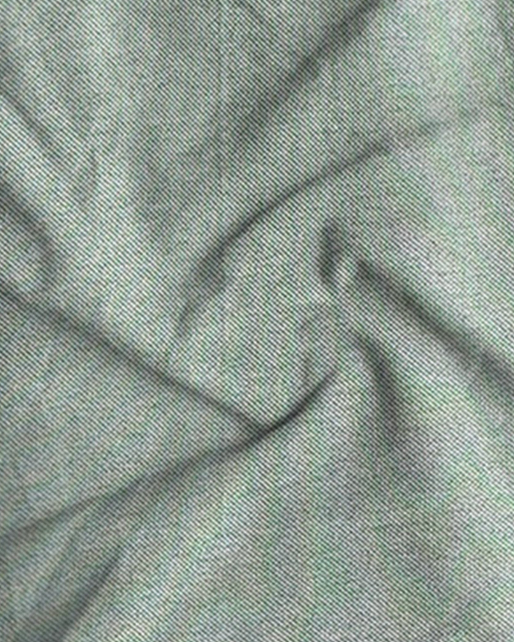 Close-up of textured green fabric with folds
