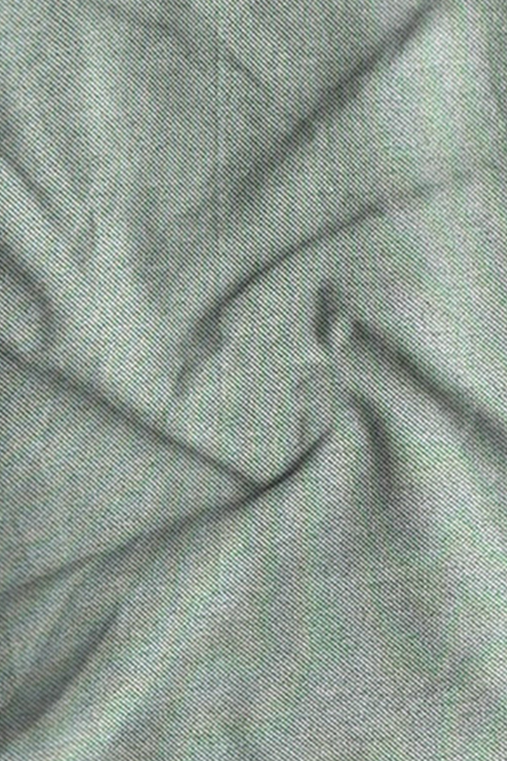 Close-up of textured green fabric with folds