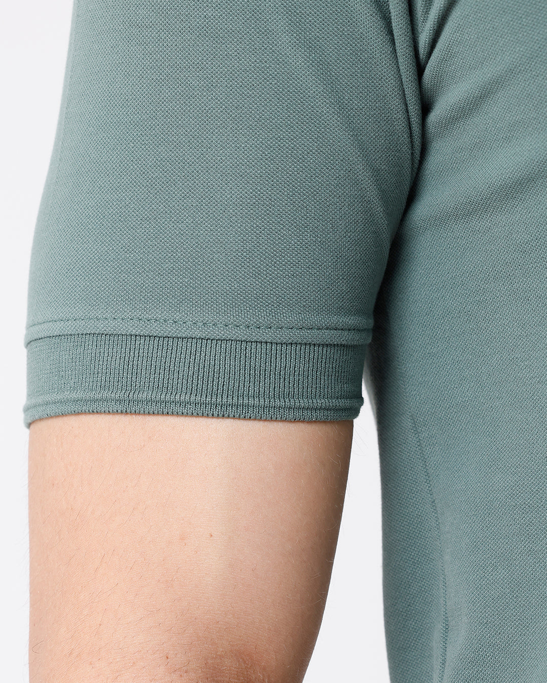 Man wearing a green iceberg green chest print slim fit polo t shirt on a light gray background
