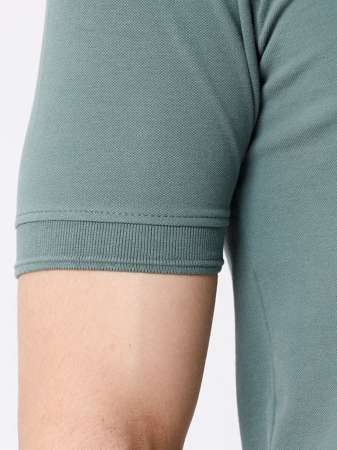 Man wearing a green iceberg green chest print slim fit polo t shirt on a light gray background