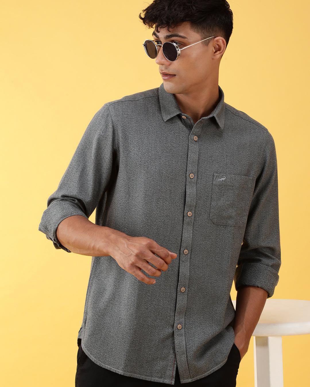 Man wearing a green green solid full sleeve casual 100% cotton shirt with casual styling on a gray background