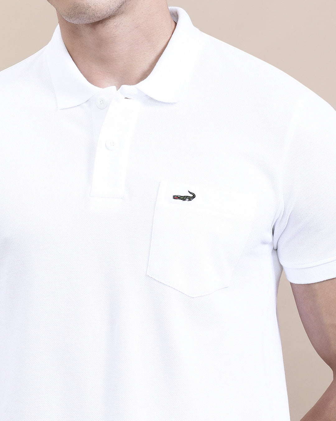 Man wearing a white white solid polo t shirt with pocket with casual styling on a gray background