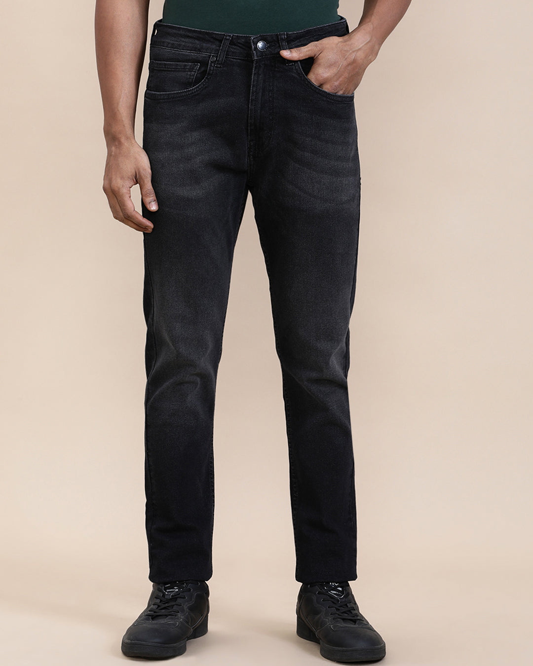 Man wearing a red natural fade wash slim tapered jeans on a light gray background