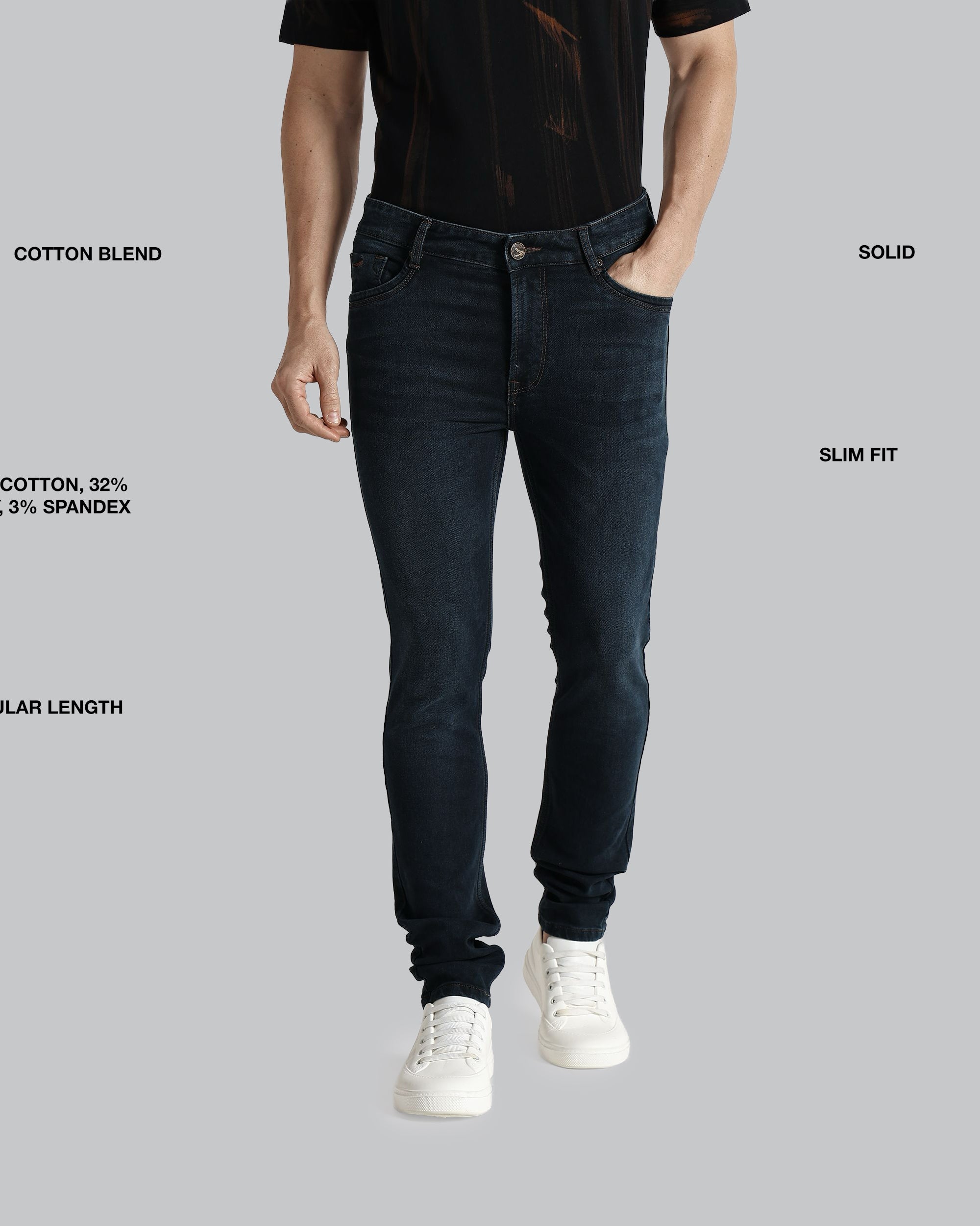 Person wearing dark jeans with text detailing fabric blend, length, and fit on a gray background