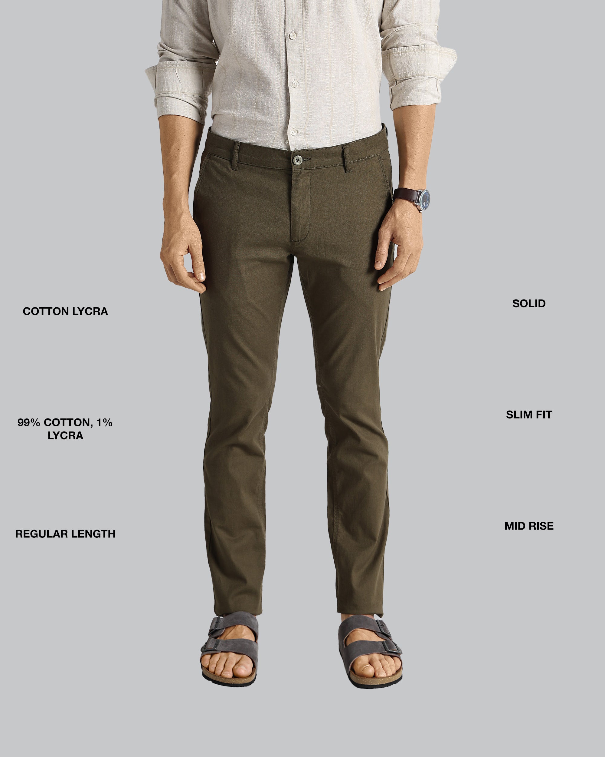 Person wearing brown pants with text detailing fabric composition, fit, and length on a gray background