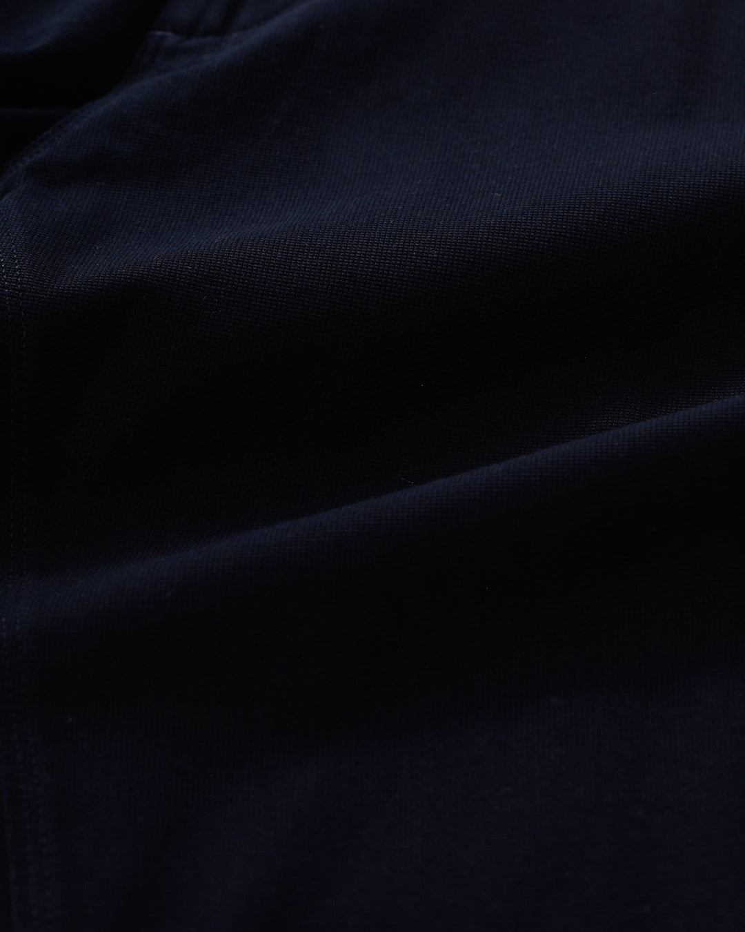 Man wearing a red textured essential chinos navy with casual styling on a gray background