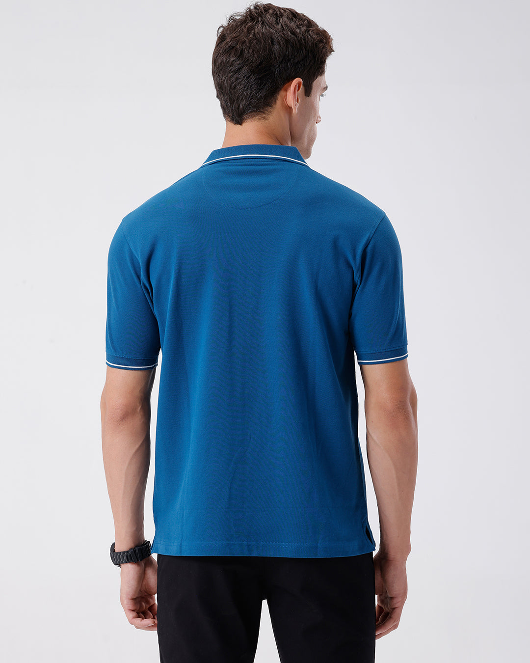 Man wearing a green iceberg green chest print slim fit polo t shirt on a light gray background