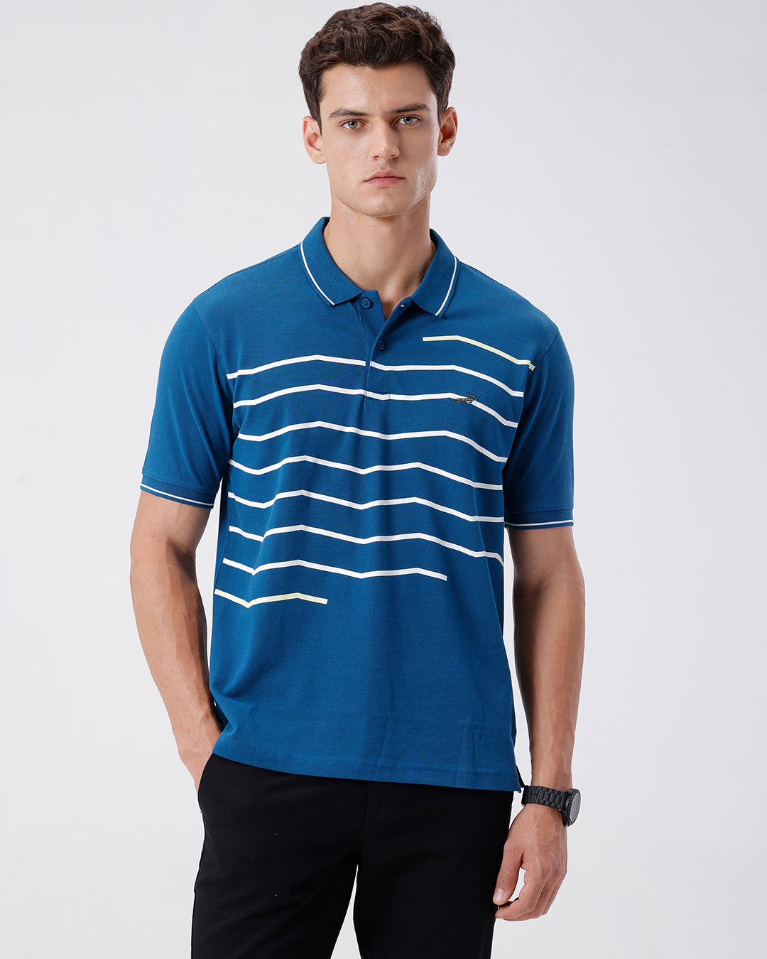 Man wearing a green iceberg green chest print slim fit polo t shirt on a light gray background