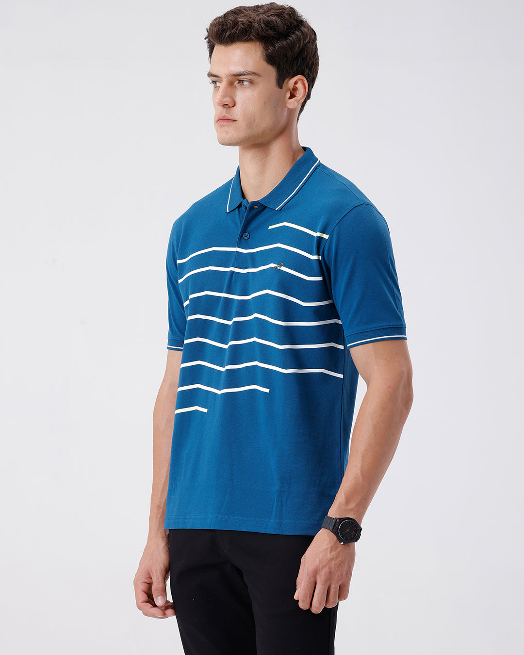 Man wearing a green iceberg green chest print slim fit polo t shirt on a light gray background