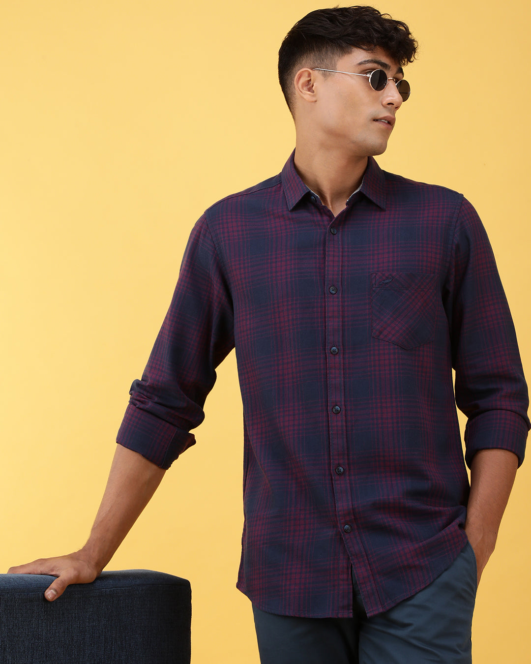 Man wearing a pink dark pink checked full sleeve 100% cotton shirt on a light gray background